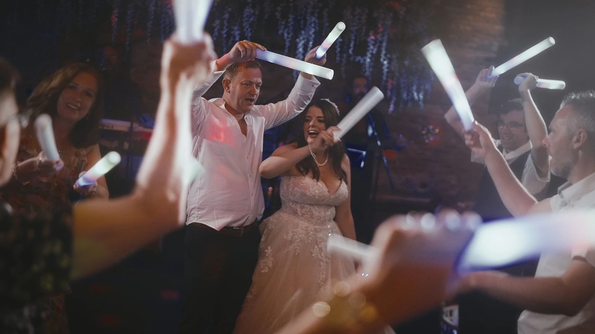 Evening celebration inside the barn at Cooling Castle Barn, filmed with cinematic pacing