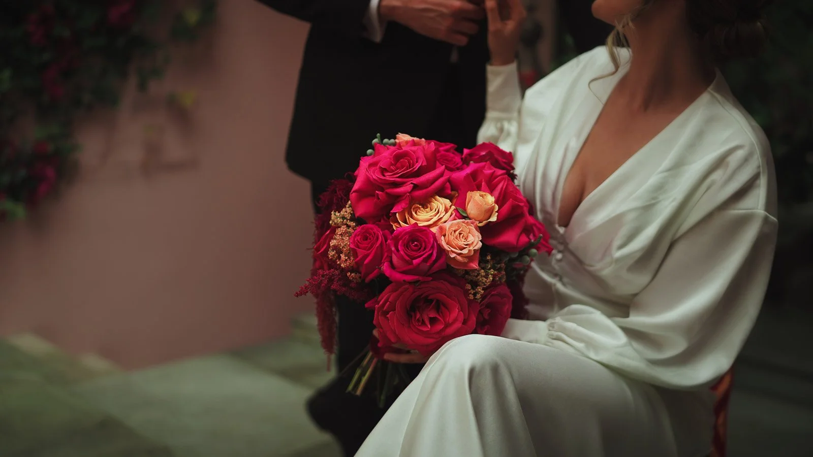 Close-up of a pink and red bouquet with rich texture, styled for colourful fine art wedding videography
