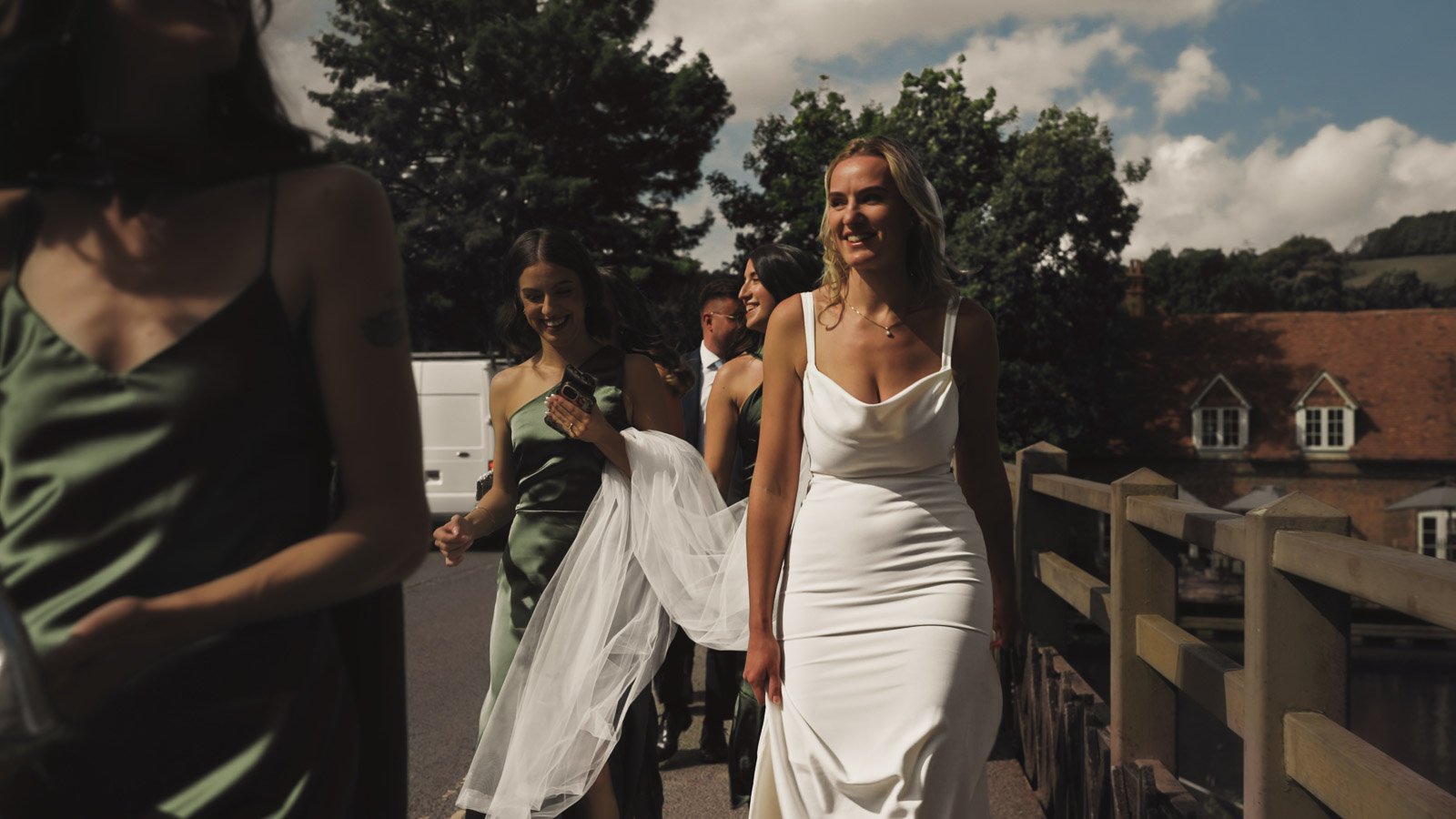 Editorial-style wedding photography from a colourful riverside celebration with bold florals and a marquee reception.