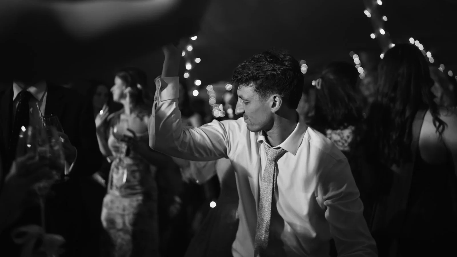 Editorial-style wedding photography from a colourful riverside celebration with bold florals and a marquee reception.