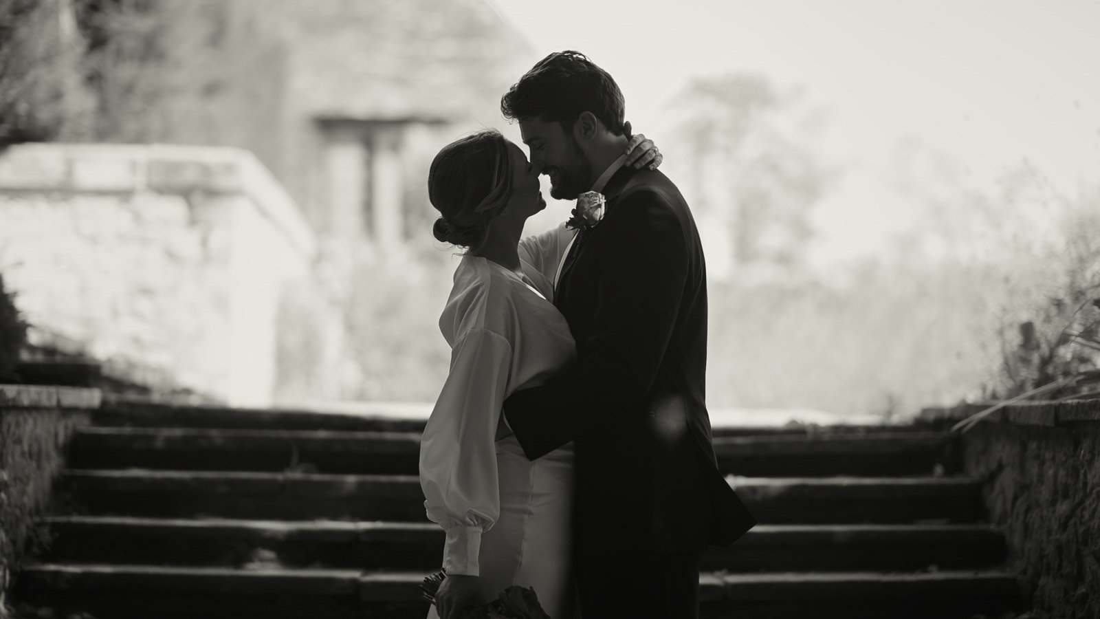 Editorial couple pose with refined finish in a fine art black and white aesthetic.