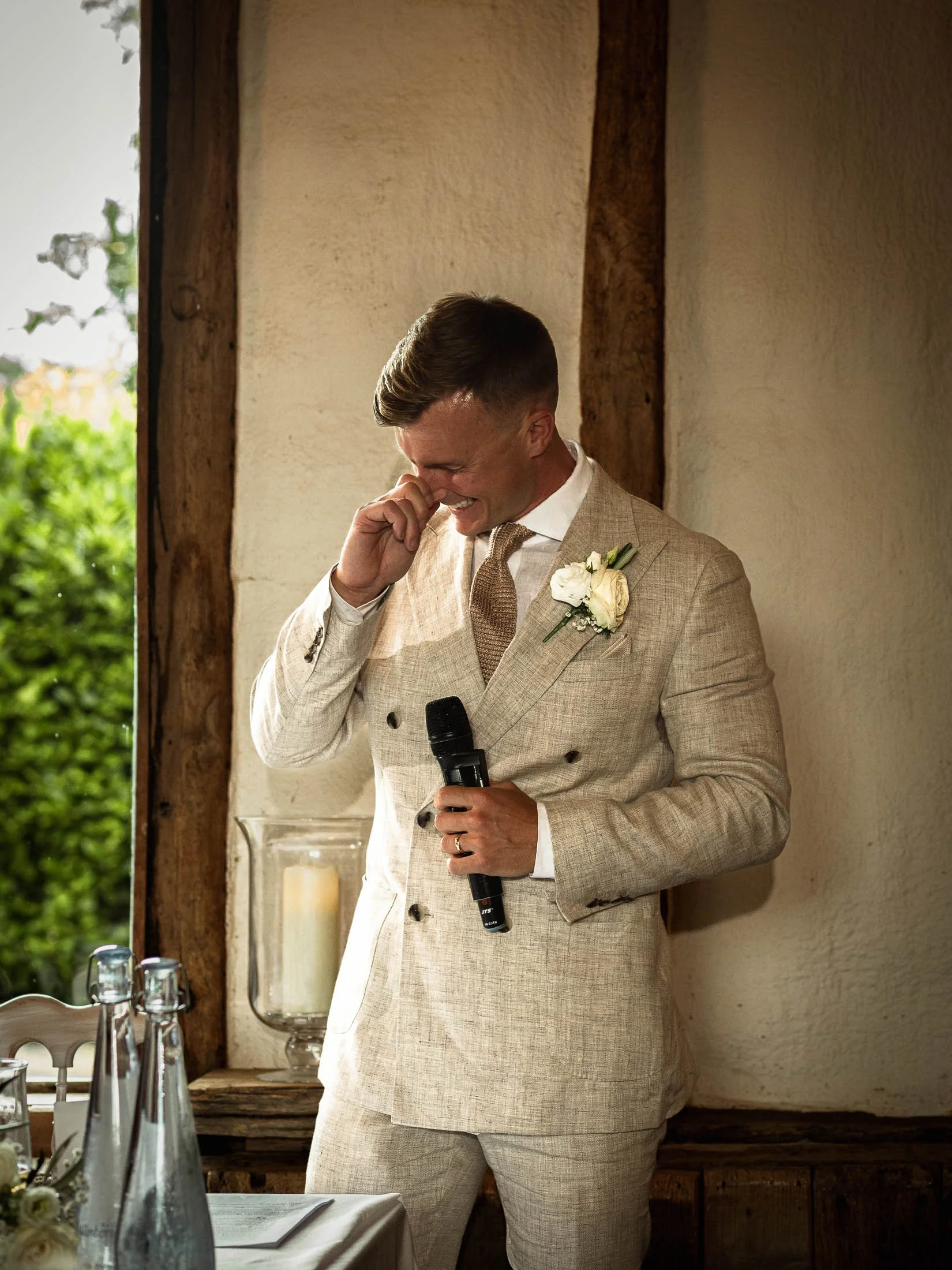 The groom laughs during his wedding speech at Winters Barns.