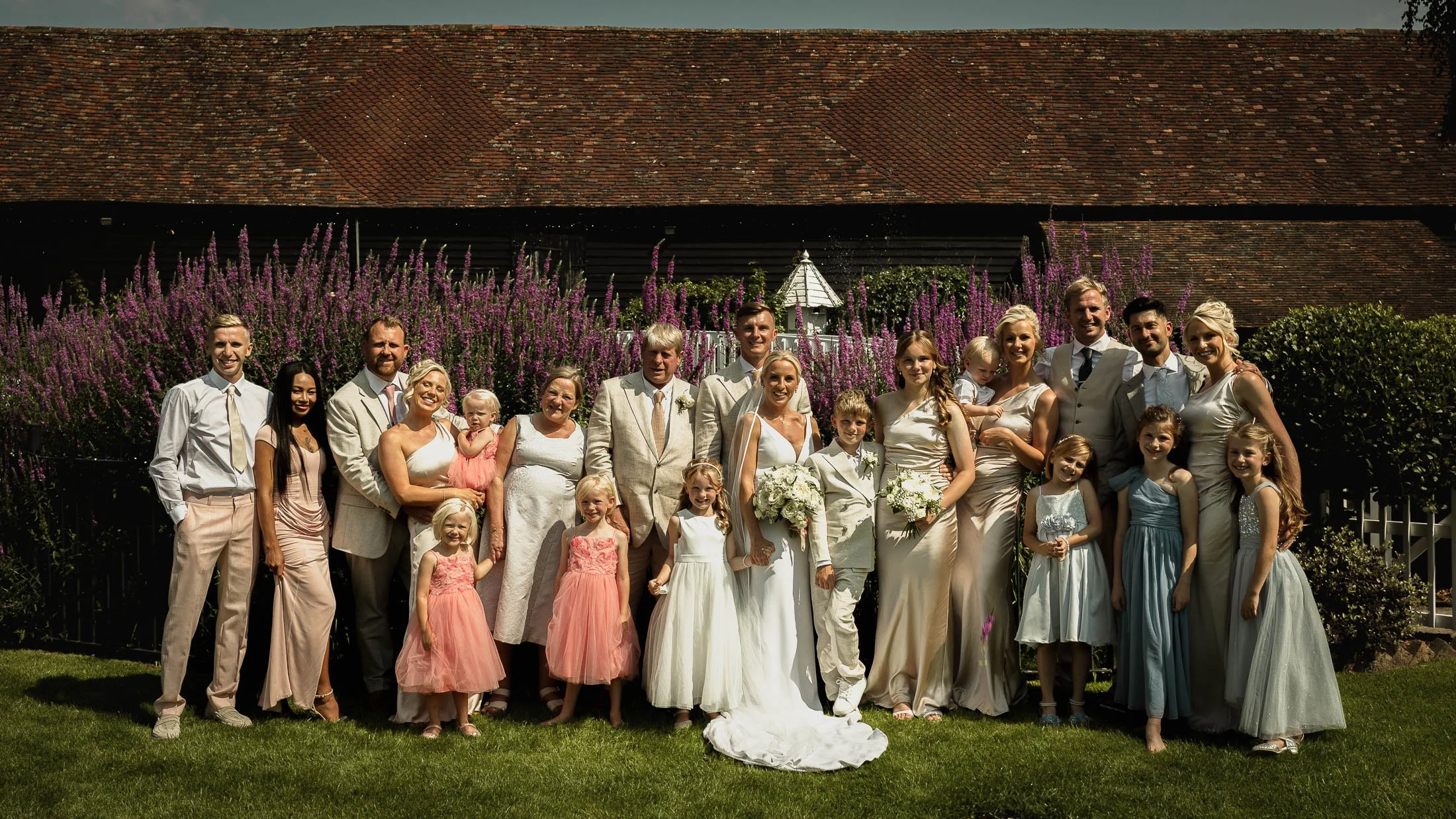 A large group shot in the gardens of Winters Barns in Kent, by the large pond and white bridge.