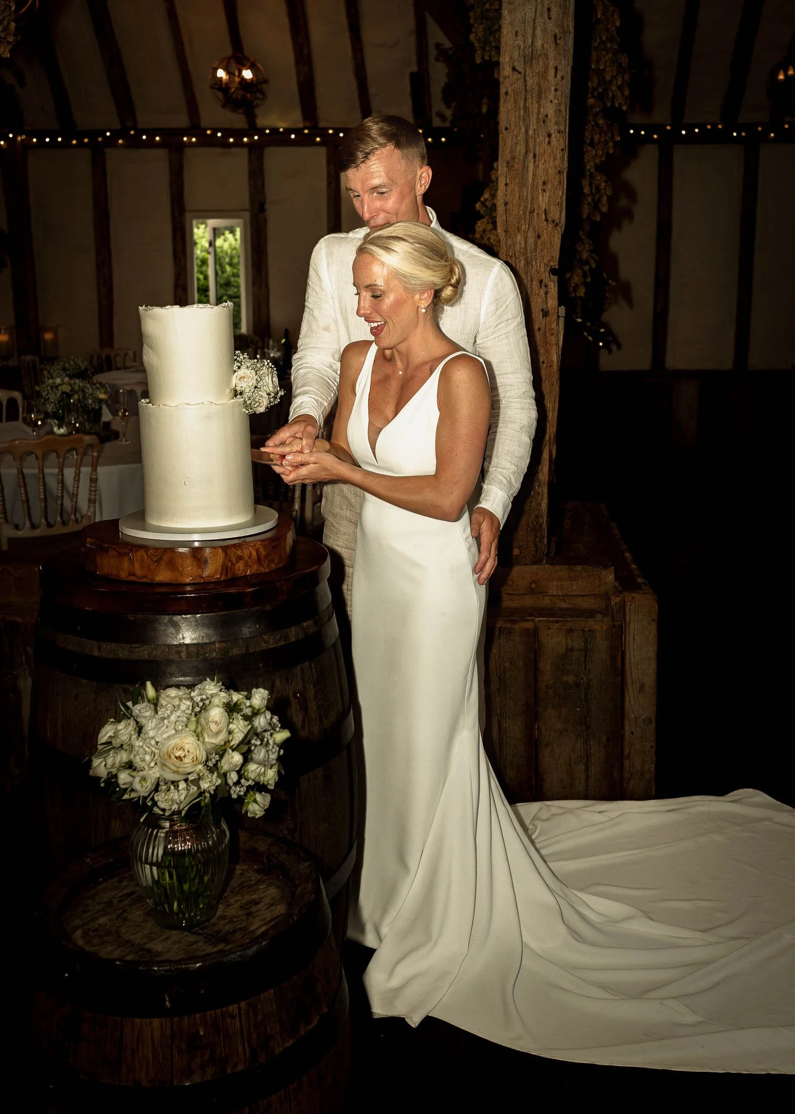 A couple cut their cake on their wedding day at Winters Barns.