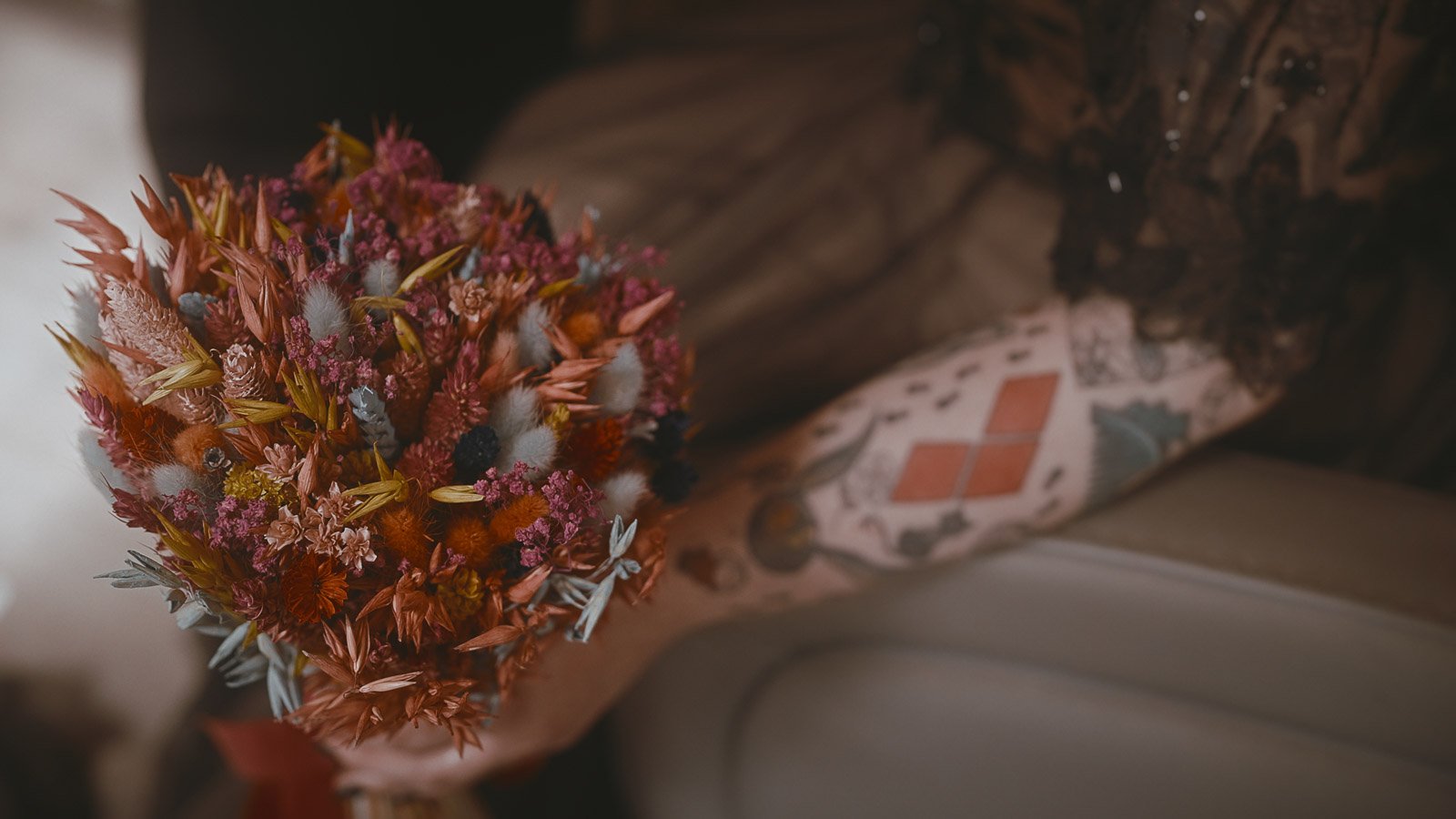 Bride’s black lace sleeves and tattoo styling captured in detail for wedding film