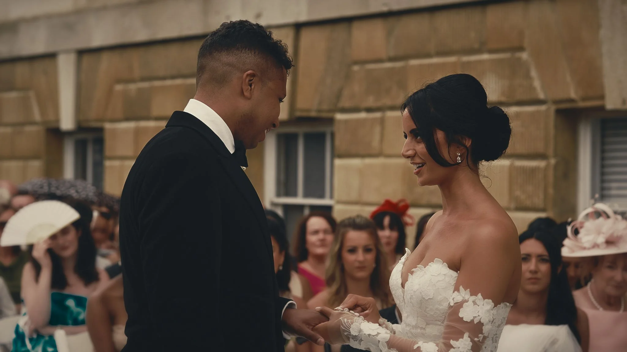 Niamh and Dominic exchanging vows during an outdoor ceremony at Botleys Mansion, captured in soft natural light.