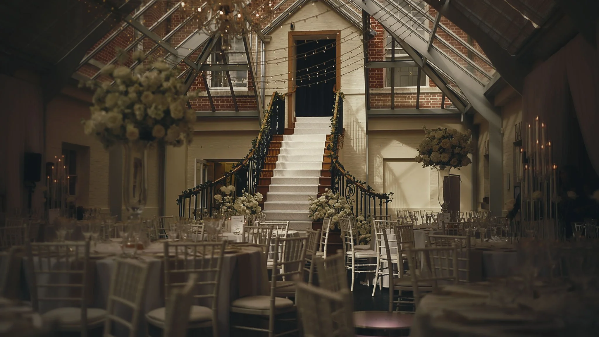 The Botleys Mansion Atrium set for the wedding breakfast with clean daylight and refined tablescape styling.
