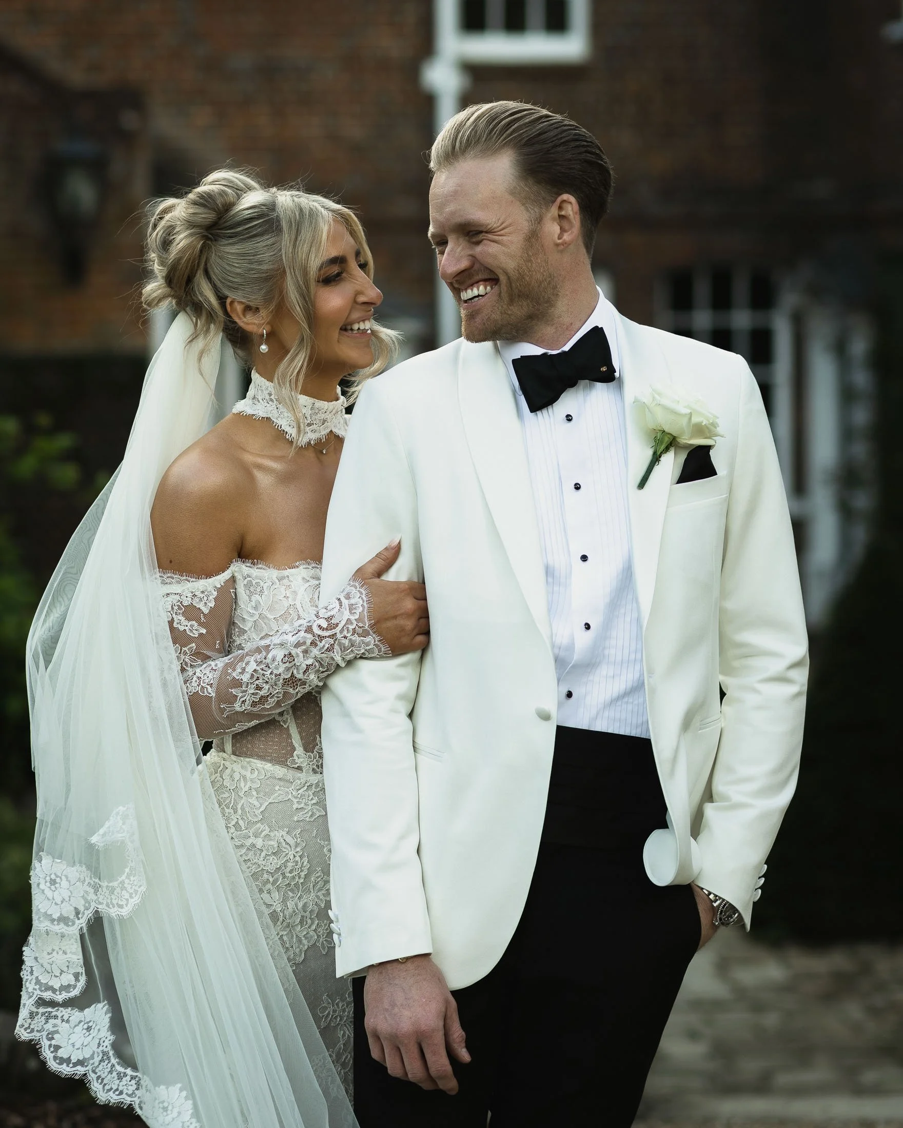 Wedding photography and videography for black-tie weddings at The Orangery Maidstone in Kent, with portraits of the bride and groom in white tuxedo.