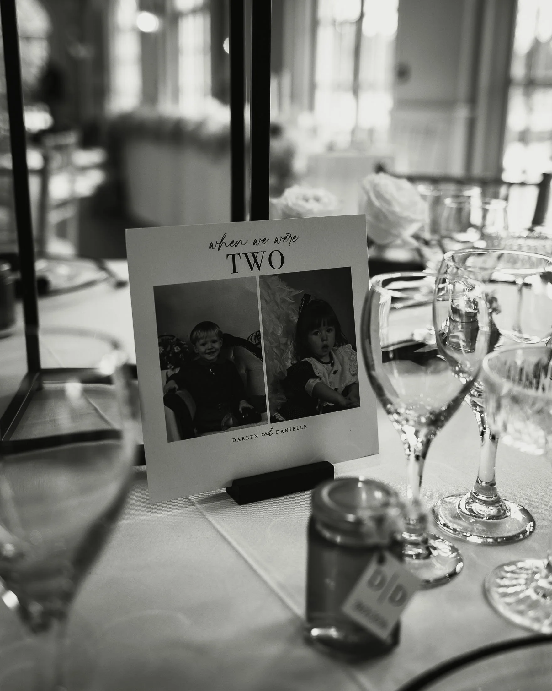 Table scape detailing and setup at a black-and-white themed wedding reception at The Orangery Maidstone.