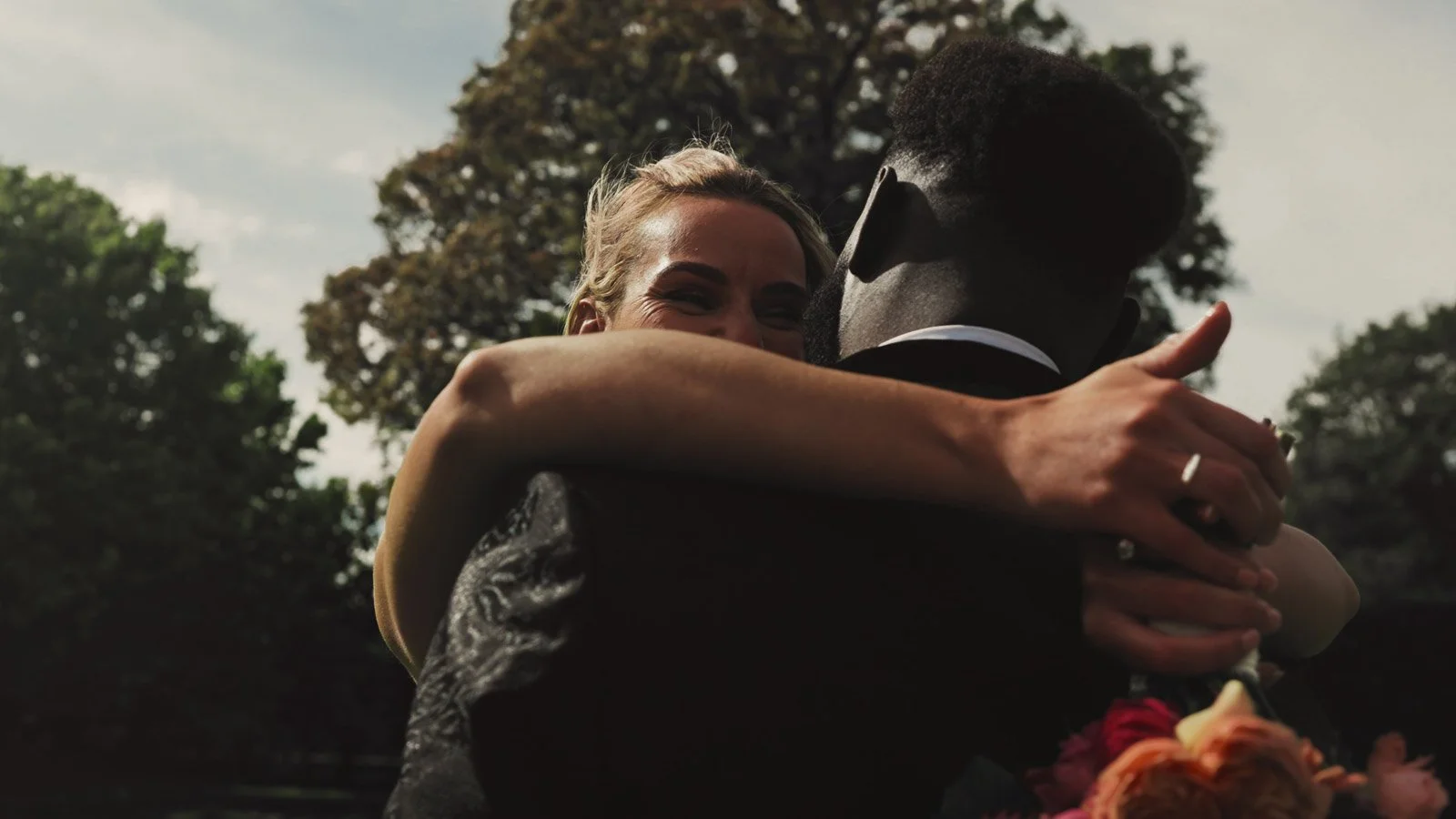 Editorial-style wedding photography from a colourful riverside celebration with bold florals and a marquee reception.