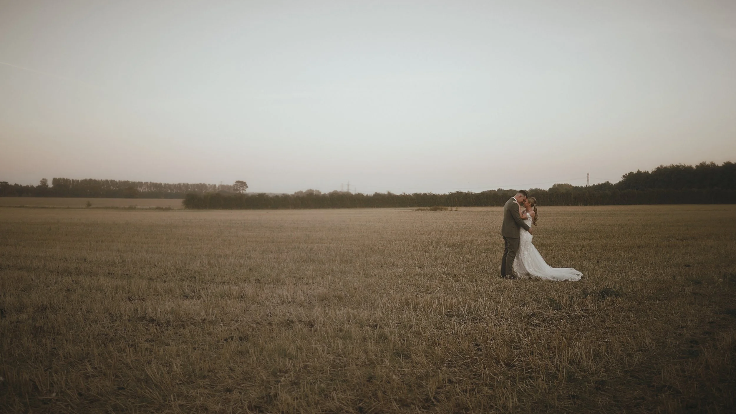 A bride and groom stand intimately together during golden hour at Winters Barns in Kent.