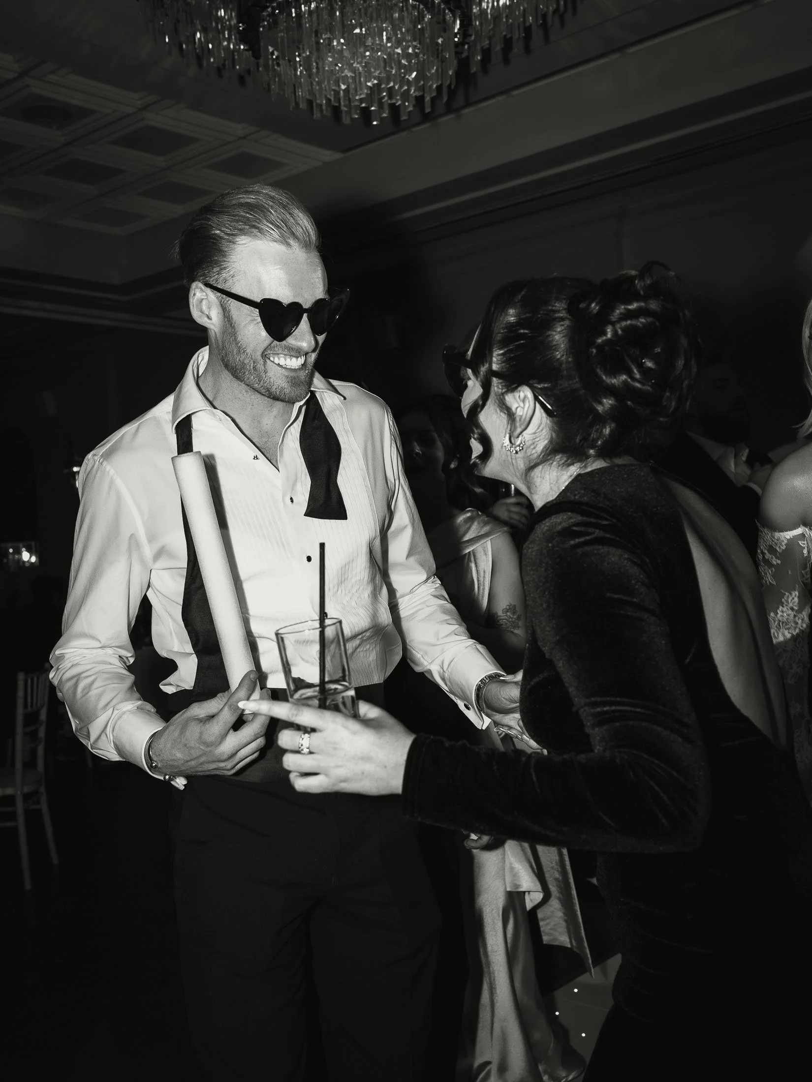 A dance floor moment during a black-tie wedding captured by a dedicated photo and video team.