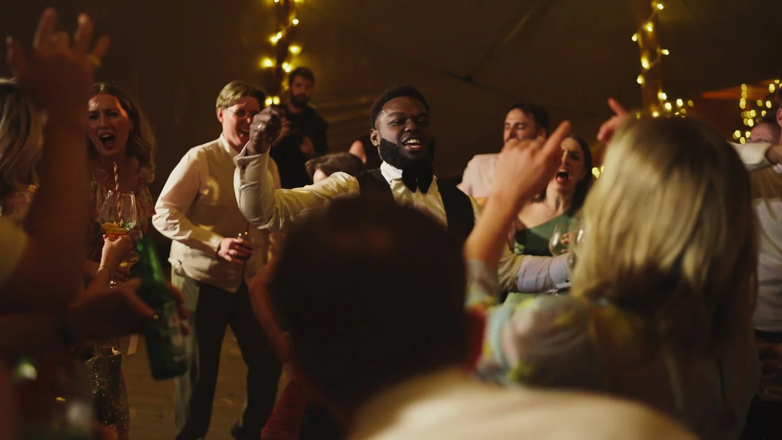 Guests and atmosphere from a colourful riverside wedding with black-tie styling and a marquee party on the Thames.