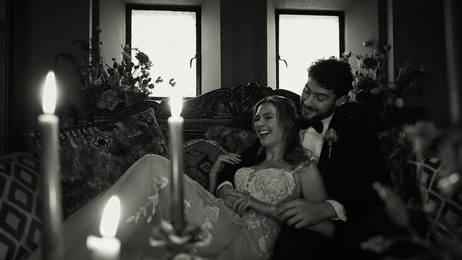 A refined editorial black and white image of a bride and groom during their evening wedding breakfast.