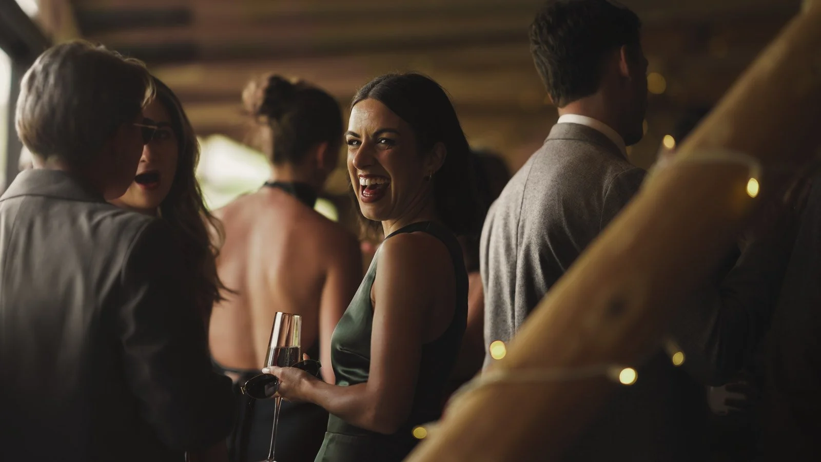 Editorial-style wedding photography from a colourful riverside celebration with bold florals and a marquee reception.