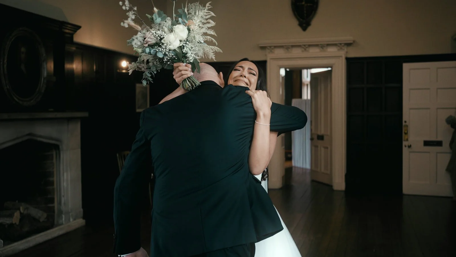 Emotive bridaal hug with father during preparations at a Kent wedding venue, captured for a cinematic wedding film.