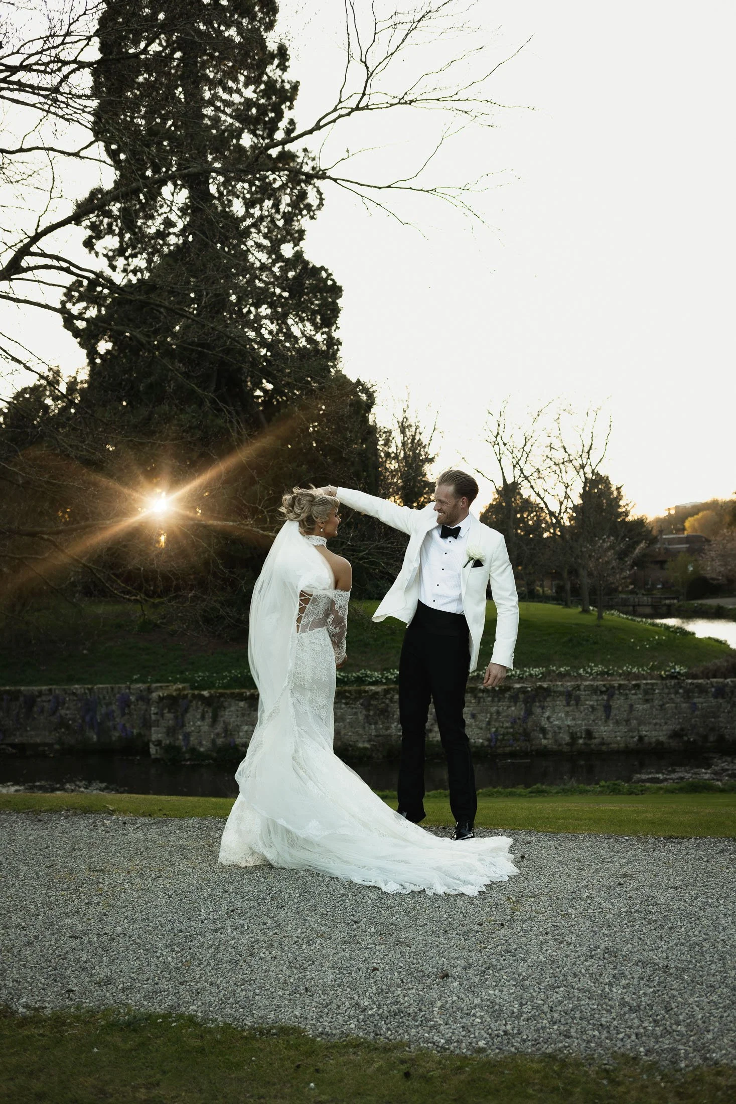 Editorial wedding photography and videography team capture a bride and groom dancing at sunset at The Orangery Maidstone wedding venue.