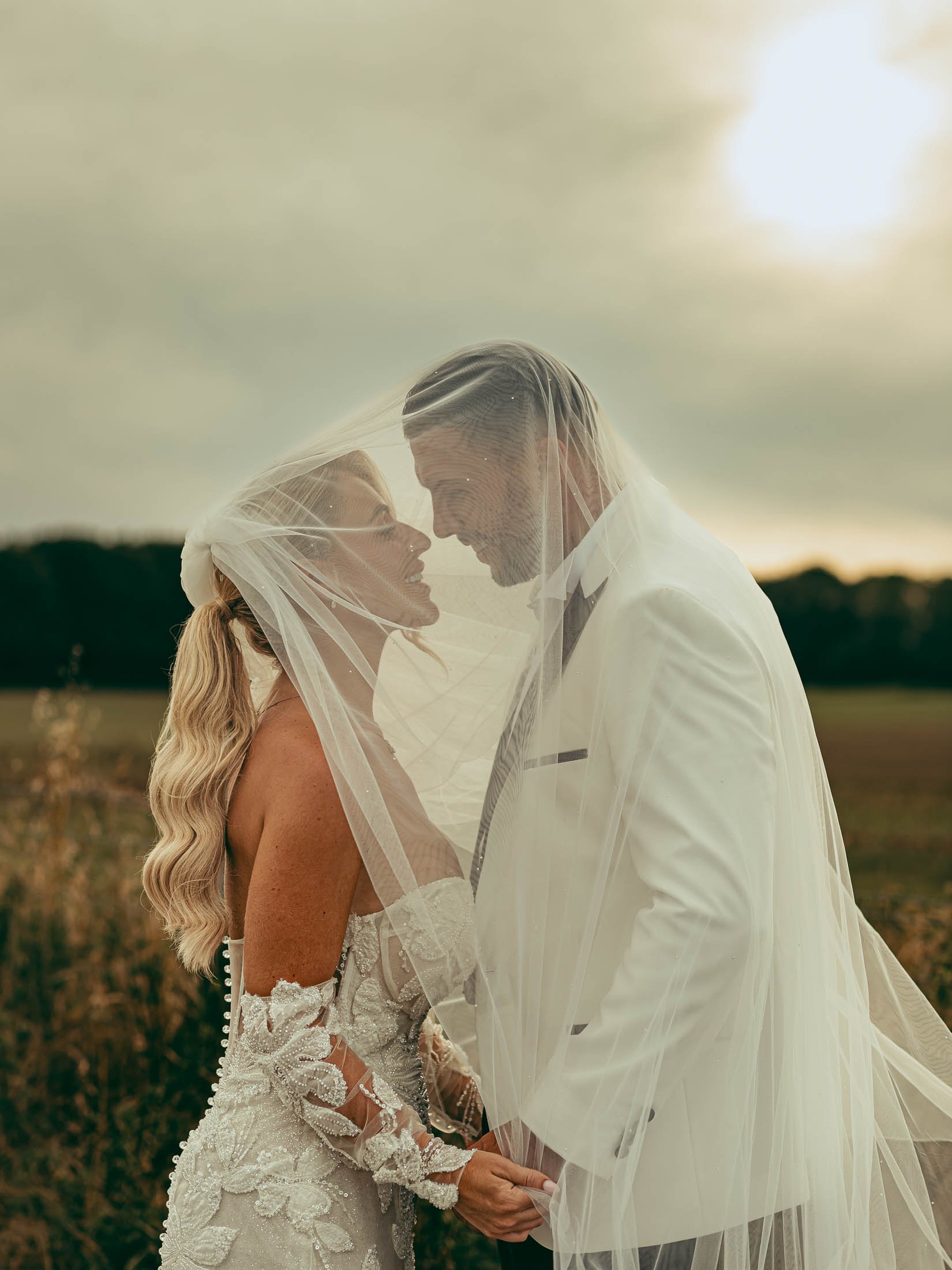 A couple pose in a fine art style as they are captured by a photo and video team in the UK.