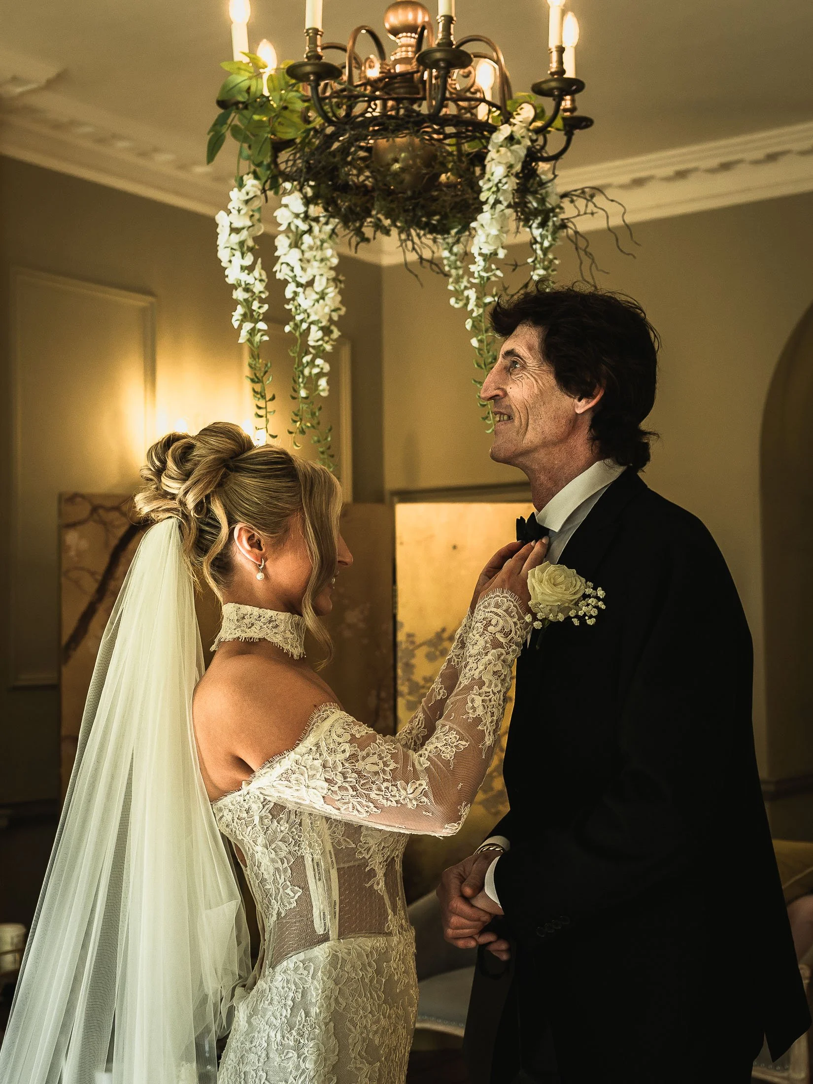 Editorial wedding videography and photography at The Orangery Maidstone as a bride straightens her Fathers bow tie.