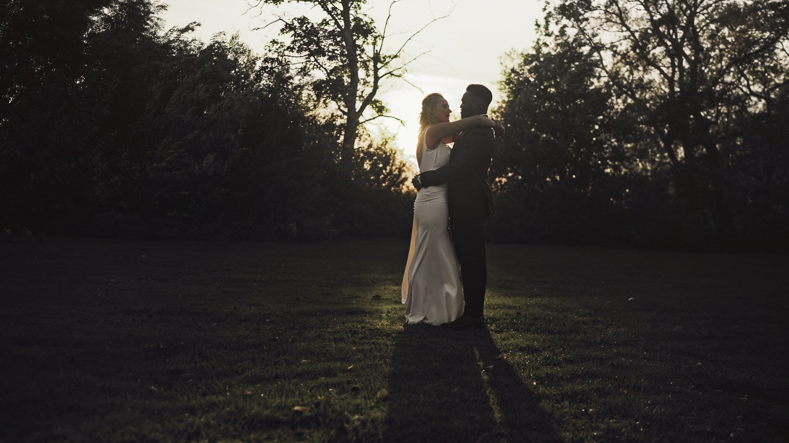 Editorial-style wedding photography from a colourful riverside celebration with bold florals and a marquee reception.