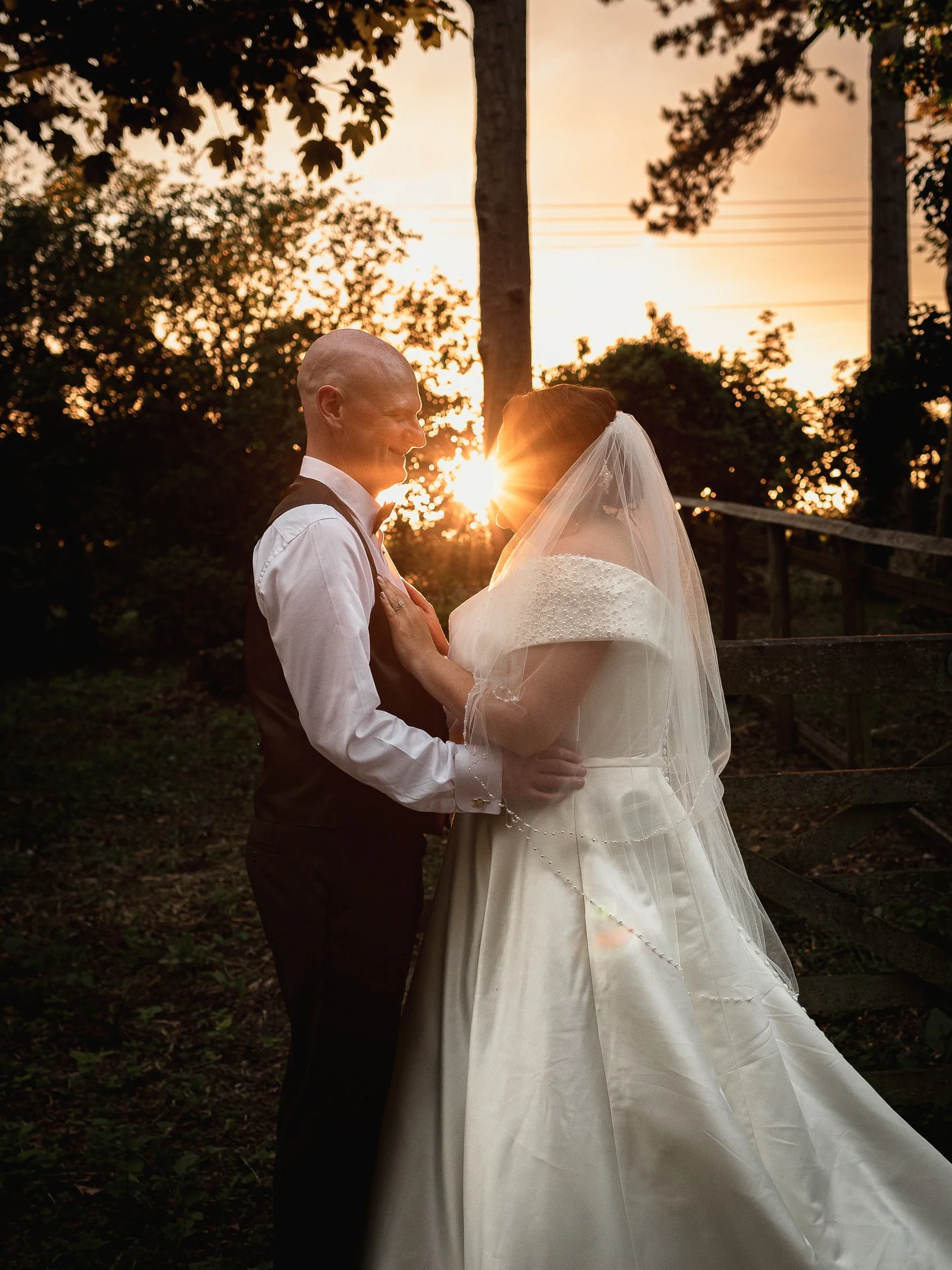 An intimate couple stand together at sunset on their Port lympne wedding day in Kent.