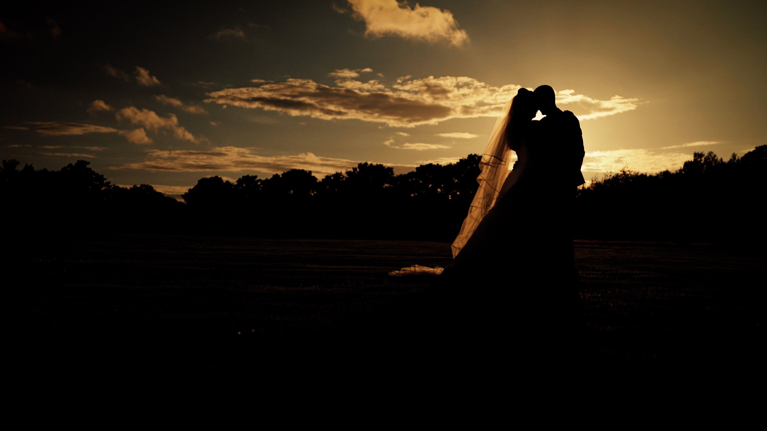 A couple at sunset during their Sussex wedding at Brookfield Barn.