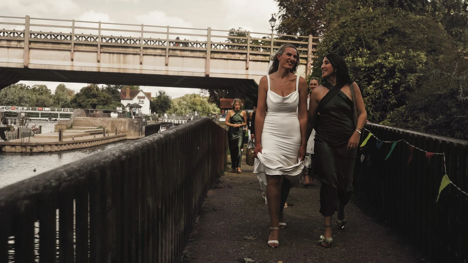 Candid moments from a colourful riverside wedding on the River Thames at an Oxfordshire country estate.