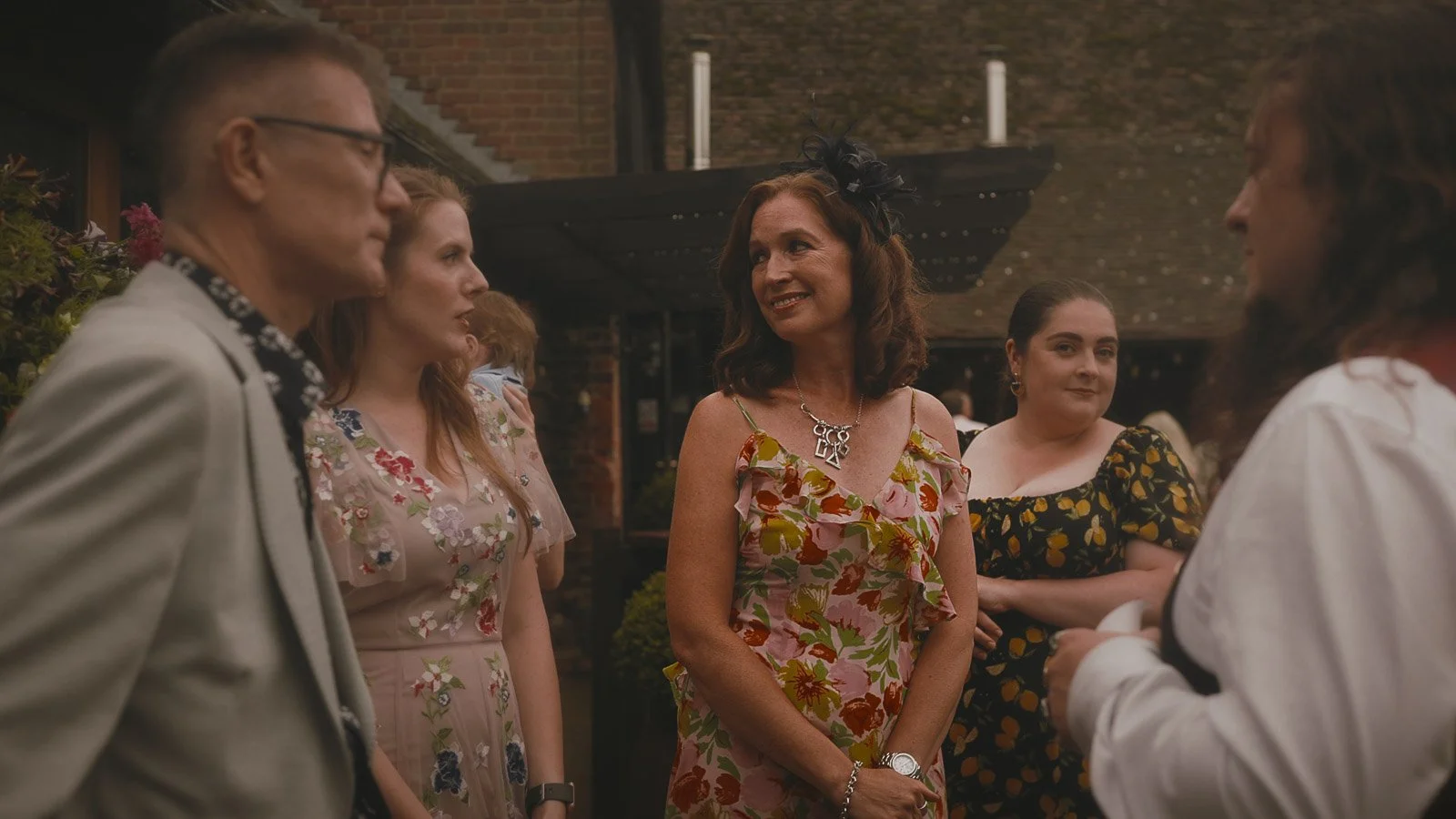 An outdoor wedding reception during a Cooling Castle wedding film.
