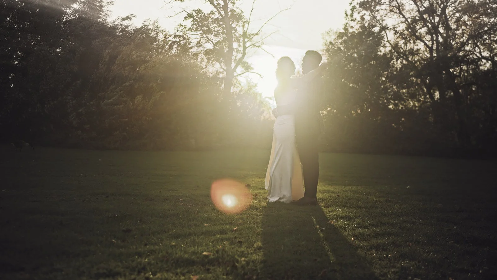 Editorial-style wedding photography from a colourful riverside celebration with bold florals and a marquee reception.