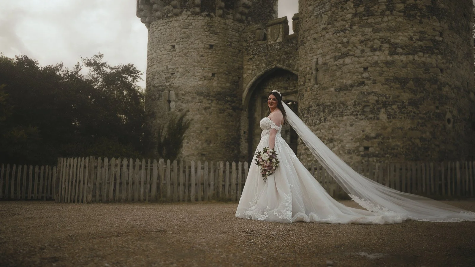 Editorial bridal portrait outside the entrance of Cooling Castle Barn wedding venue.
