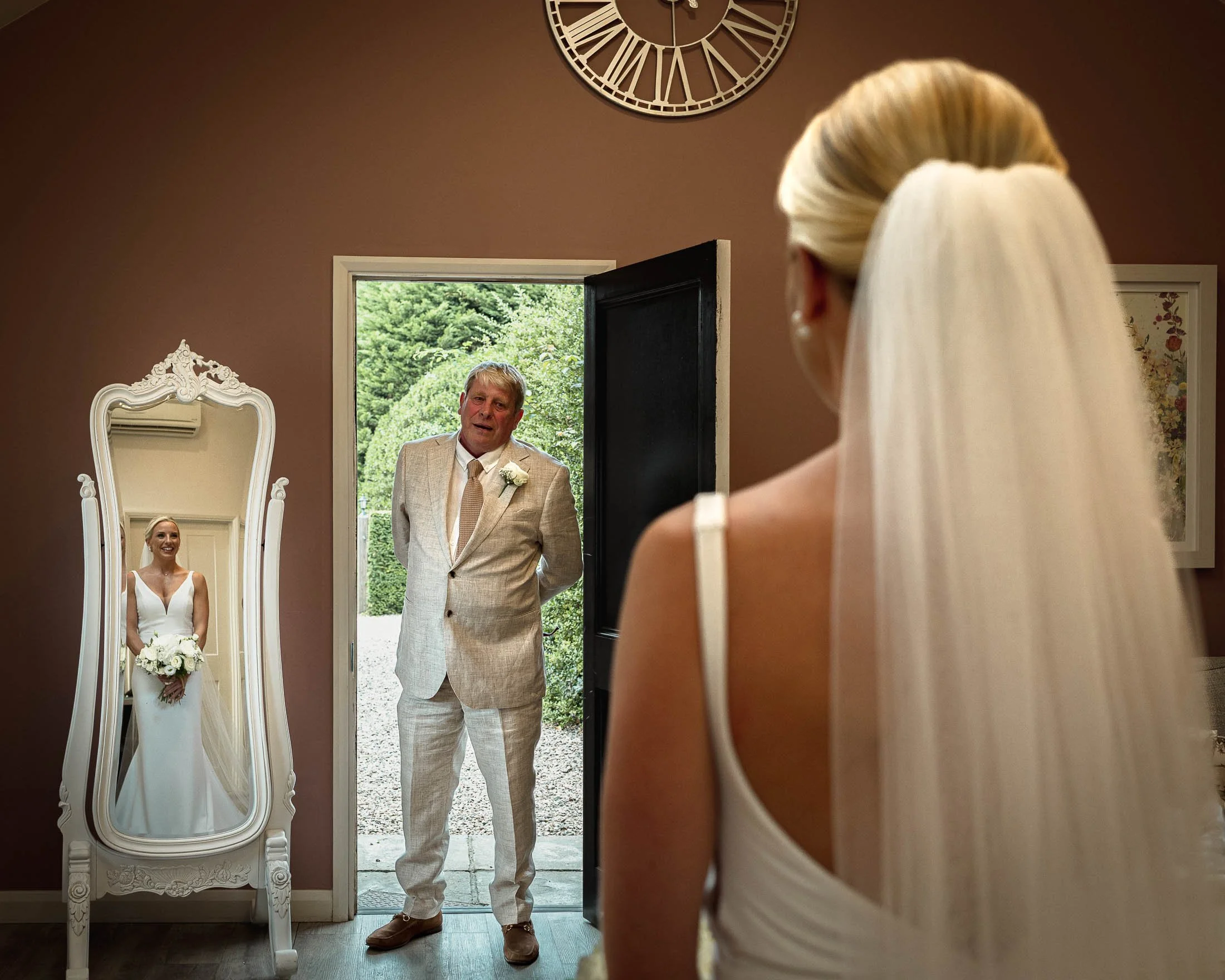 A fathers reaction to seeing his daughter for the first time in her wedding dress in the bridal prep salon at Winters Barns.
