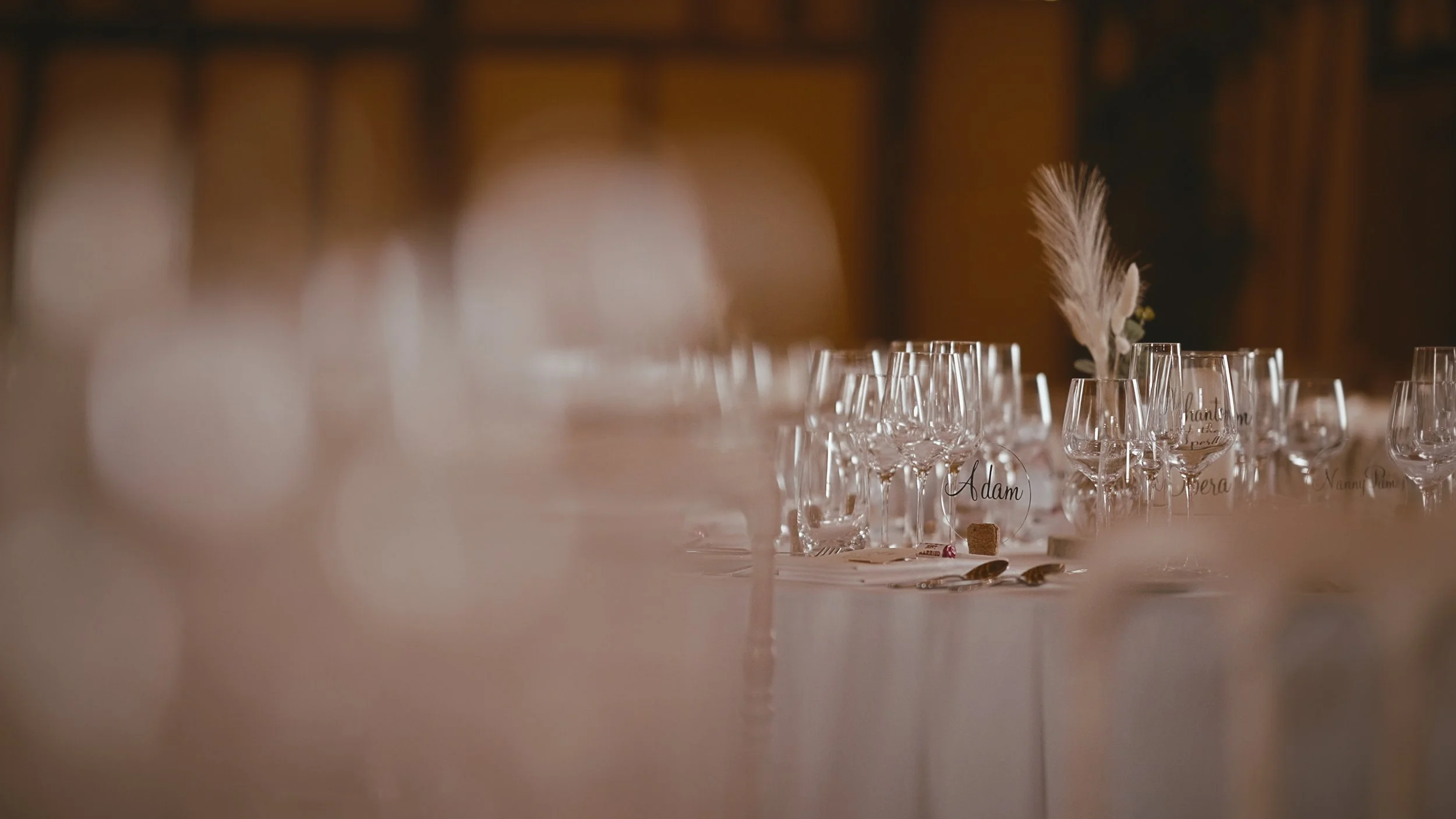Glasses and pampas grass set up on tables ready for a wedding breakfast at Winters Barns.