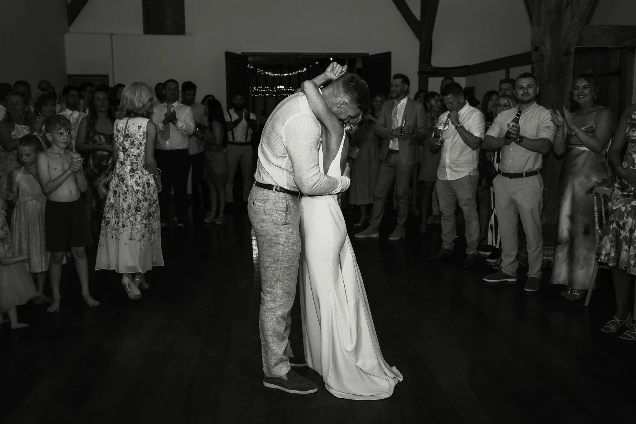 A couple share their first dance surrounded by their friends and family at Winters Barns.