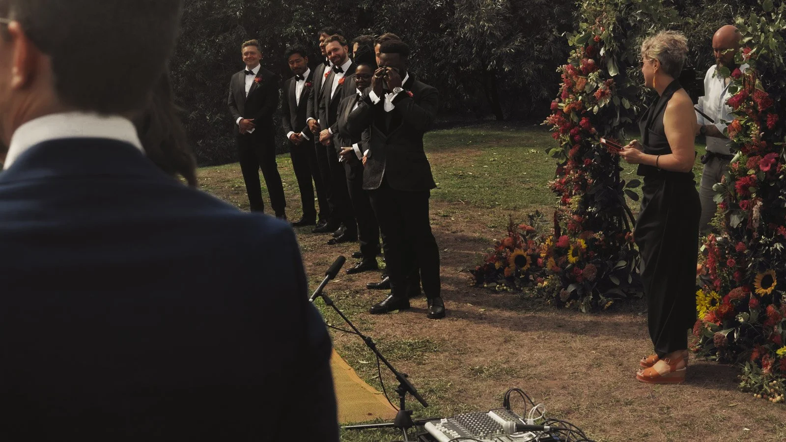 Editorial-style wedding photography from a colourful riverside celebration with bold florals and a marquee reception.