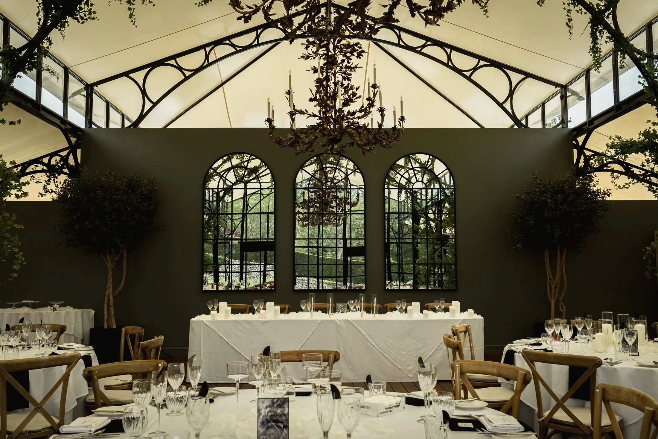 Inside the Glass Orangery at Port Lympne in Kent as it is dressed ready for a wedding breakfast.