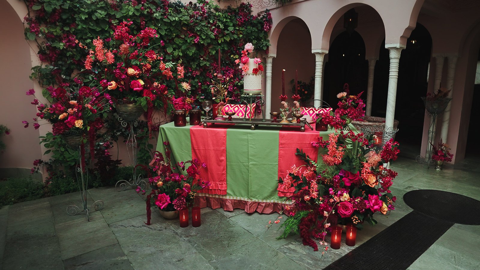 Place setting detail with vivid florals and refined editorial styling that feature a bold pink and red colour scheme