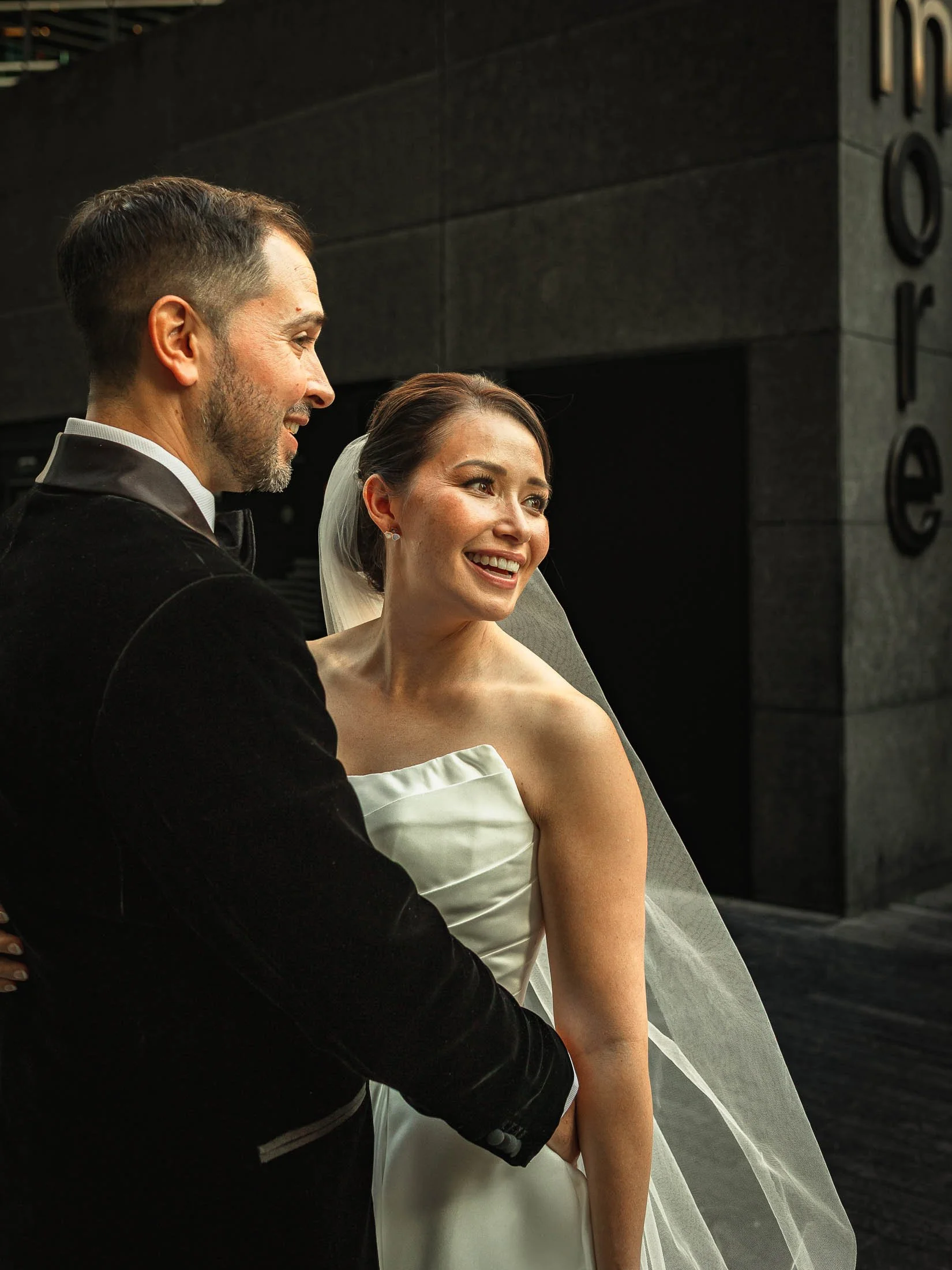 A romantic couples portrait showing a bride and groom smiling together during their luxury London wedding day.