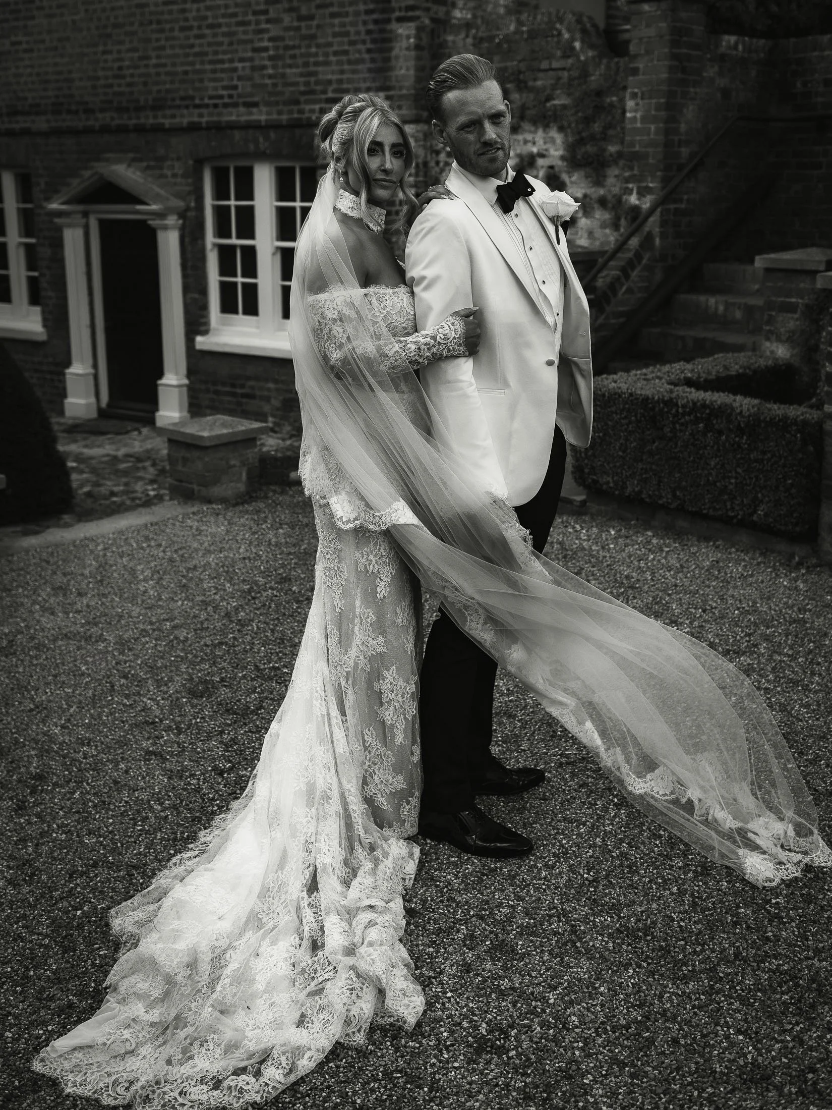 White tuxedo groom and bride portrait at The Orangery Maidstone wedding in Kent.