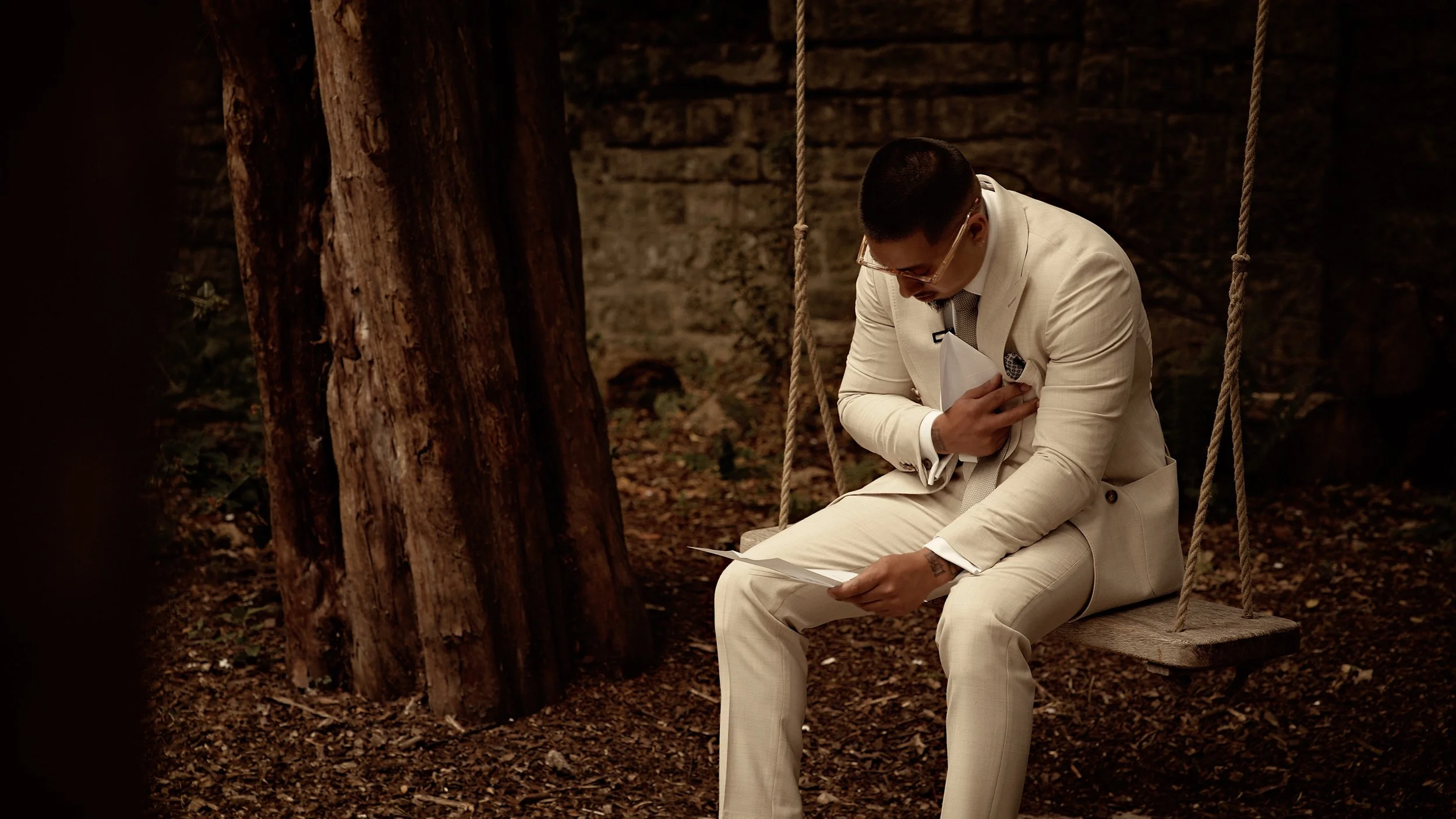 Emotional groom cries during wedding preparations as he reads a letter from the bride at The Orangery Maidstone in Kent