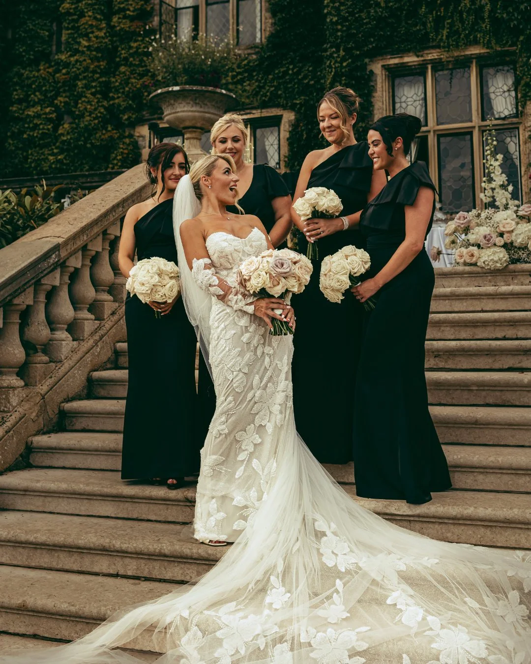 Bridesmaids laugh togther on steps as they are captured by a wedding video and photo team in Kent.