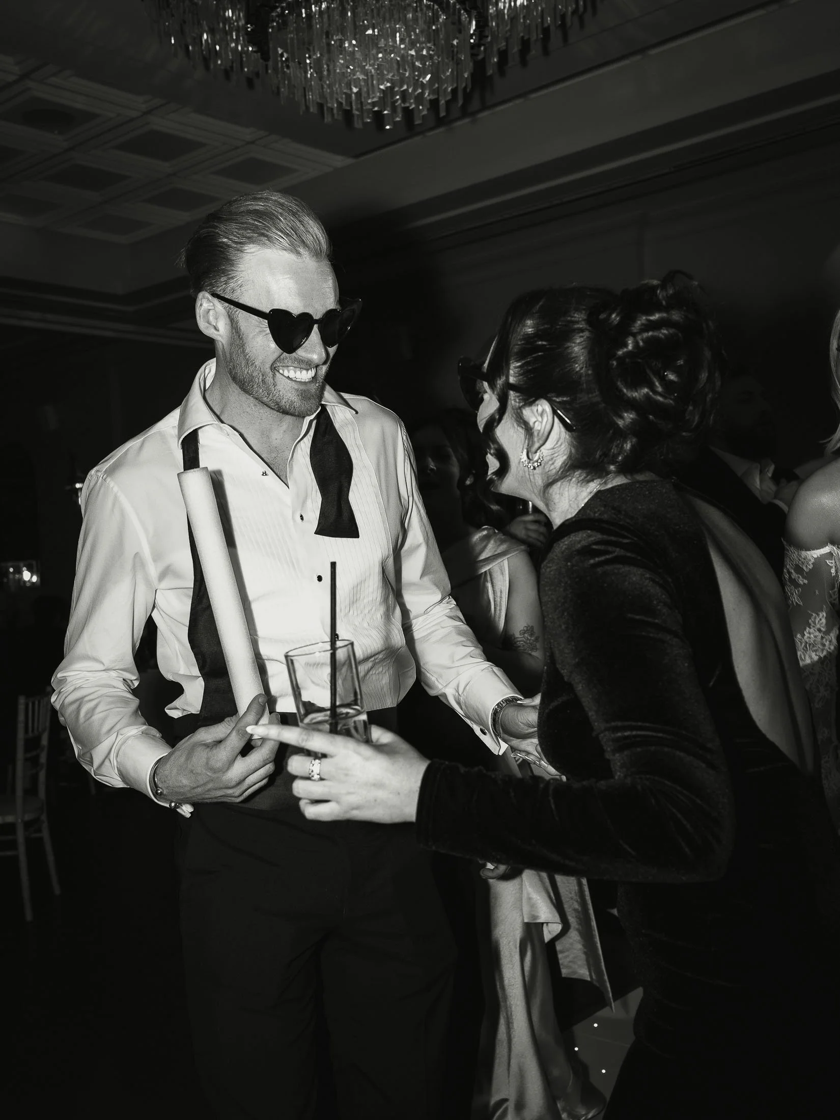 Groom in relaxed black-tie celebrates and dances during a wedding after-party at The Orangery Maidstone in Kent.