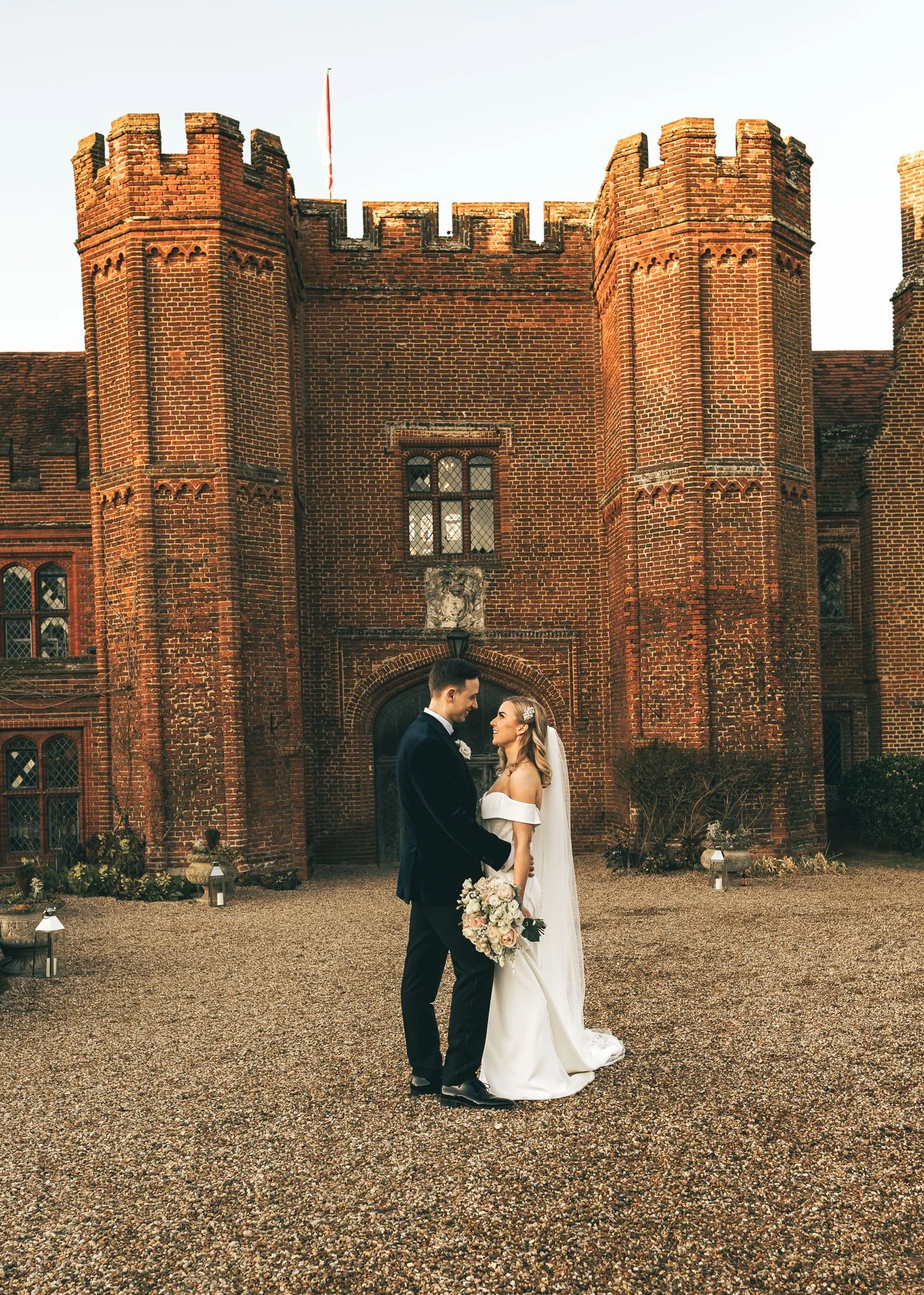 A couples portrait moment from a black tie winter wedding at Leez Priory in Essex, captured by a dedicated wedding photo and video team.