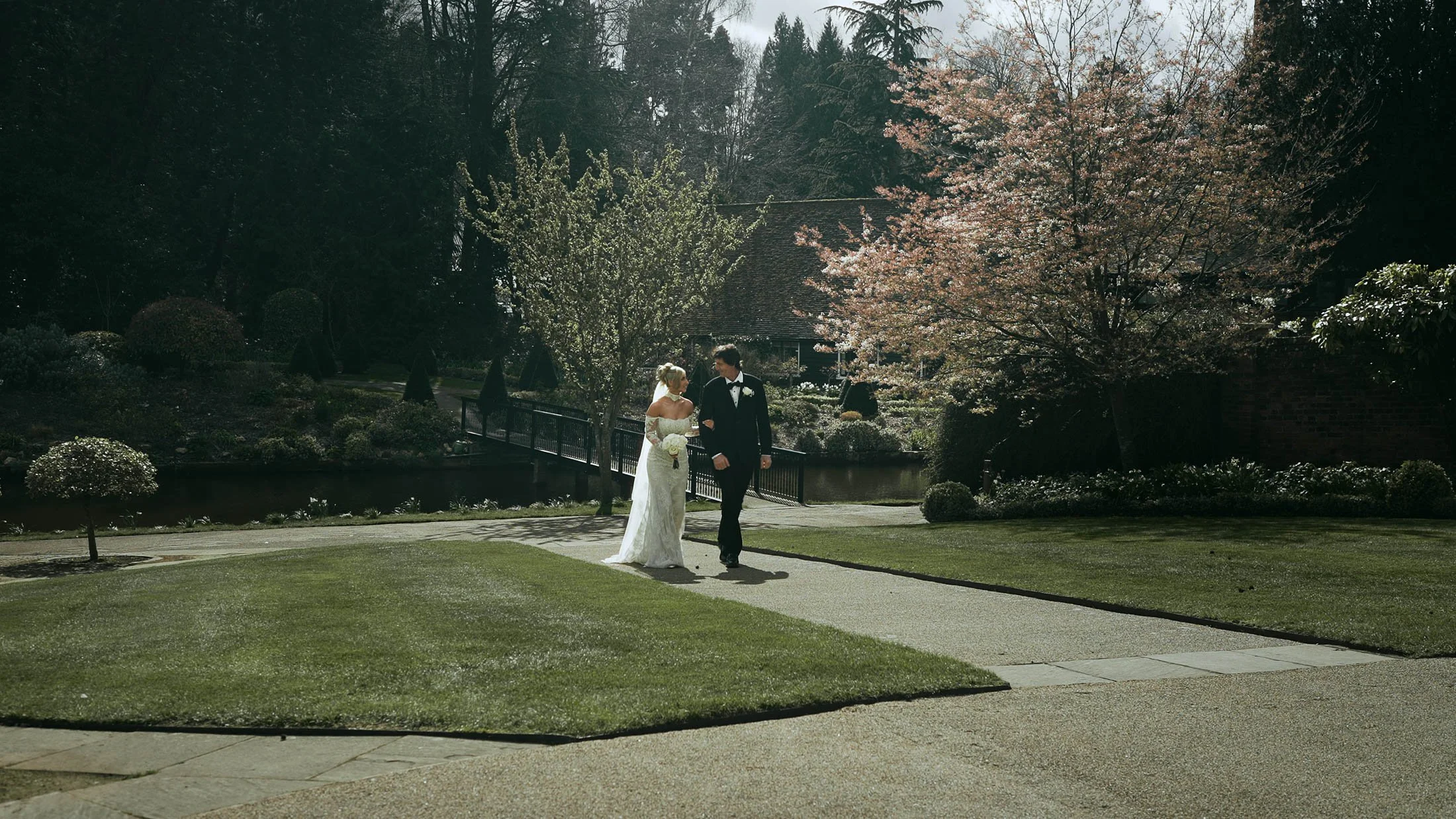 A bride walking arm-in-arm with her Father on the way to her indoor ceremony at The Orangery Maidstone.