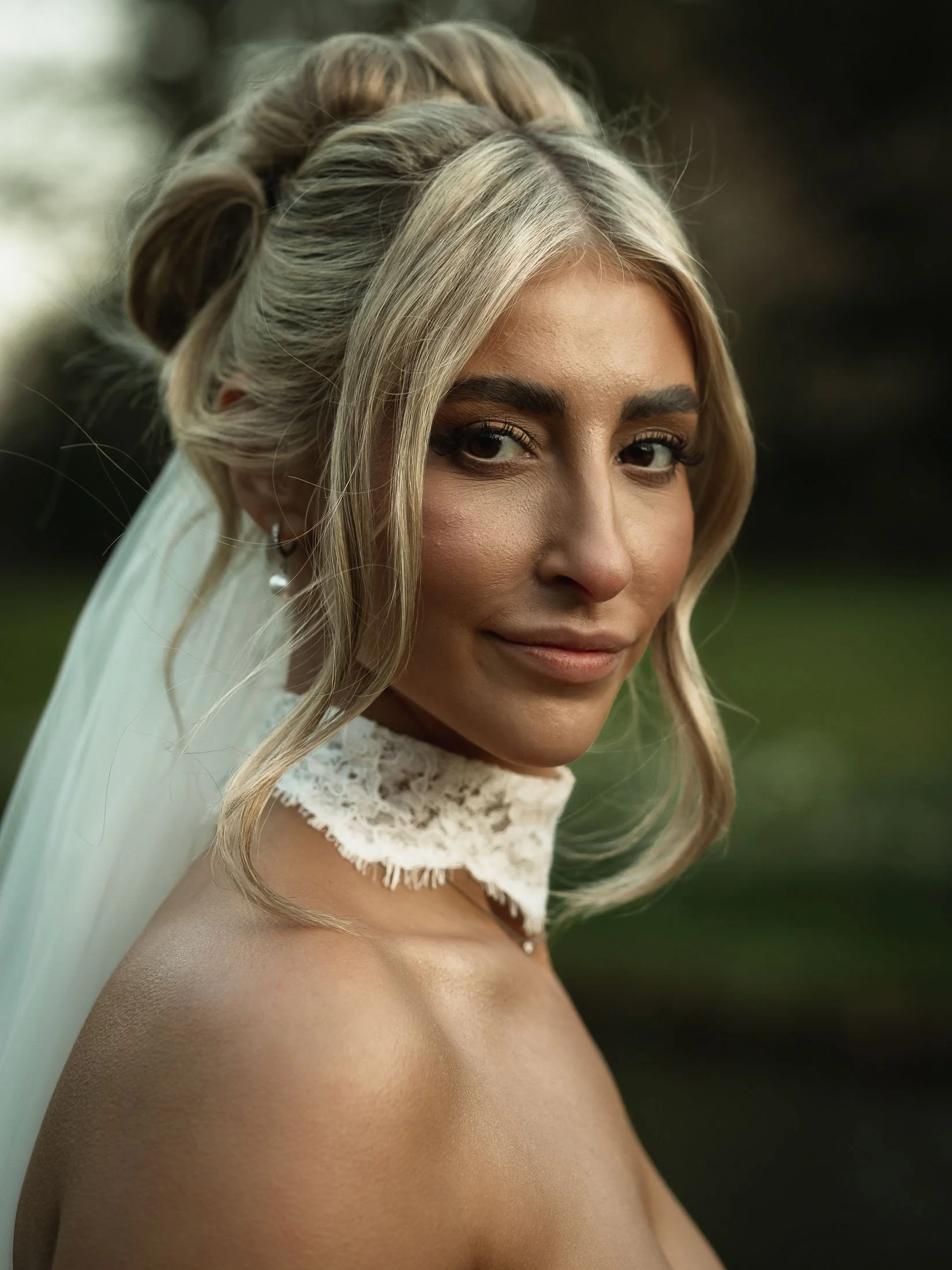 A close up editorial portrait of a bride during her luxury wedding at The Orangery Maidstone in Kent.
