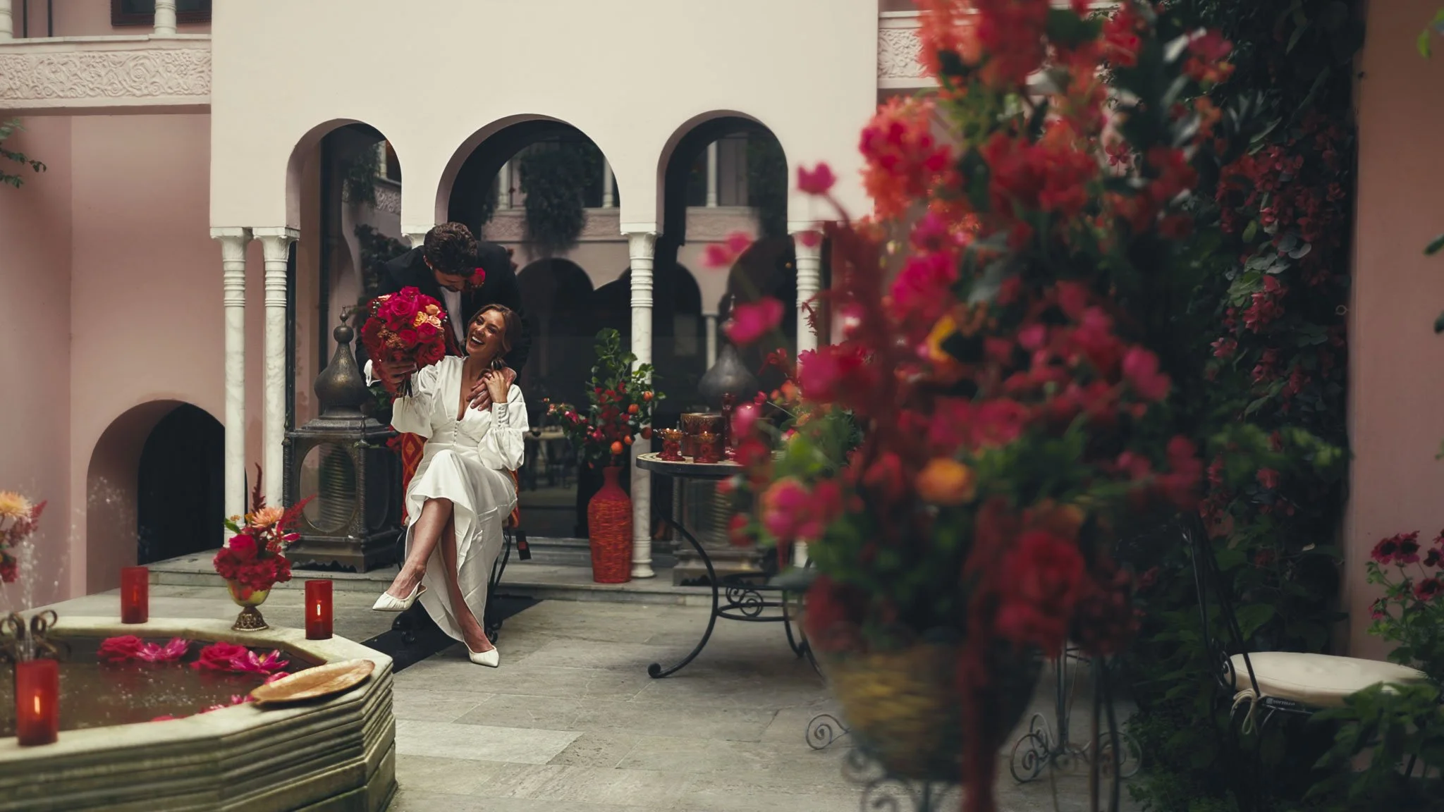 Editorial wedding portraits in Port Lympne’s Moroccan Courtyard with blush-toned walls and layered texture.