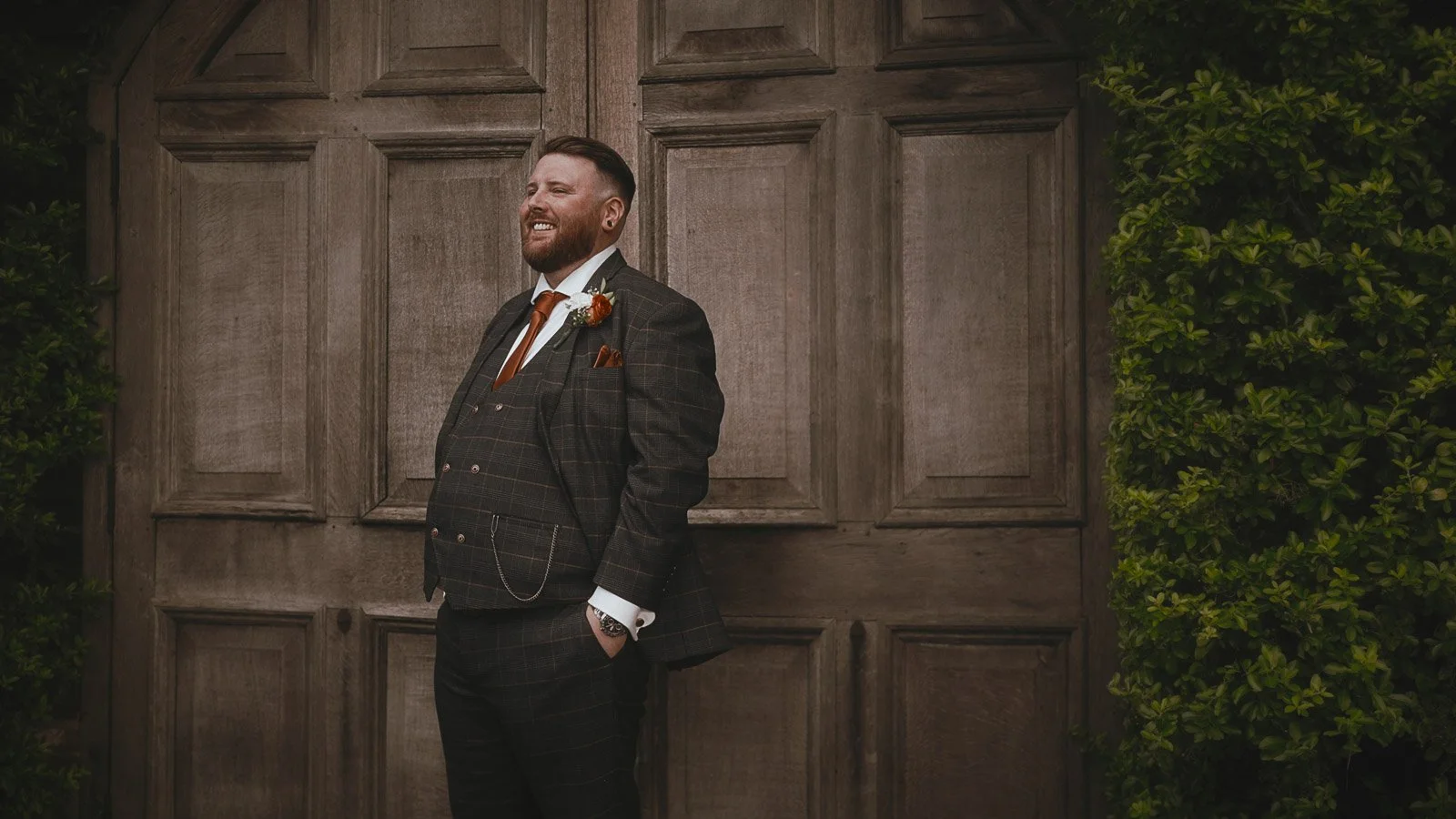 The groom poses for an editorial portrait in this wedding film moment from Winters Barns, Kent.