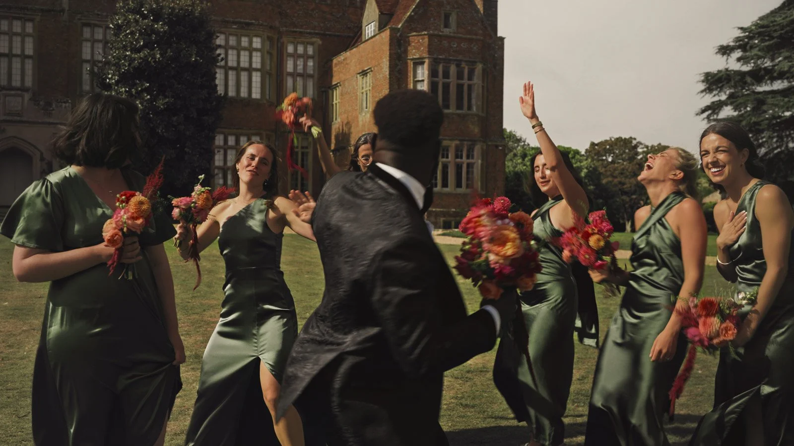 Editorial-style wedding photography from a colourful riverside celebration with bold florals and a marquee reception.