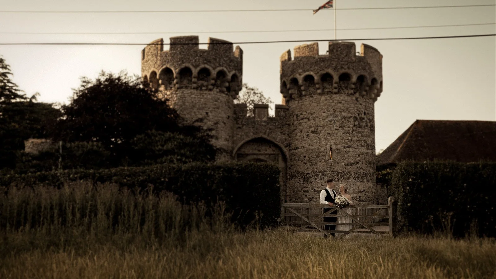 Cinematic establishing shot of Cooling Castle Barn wedding venue grounds in Kent