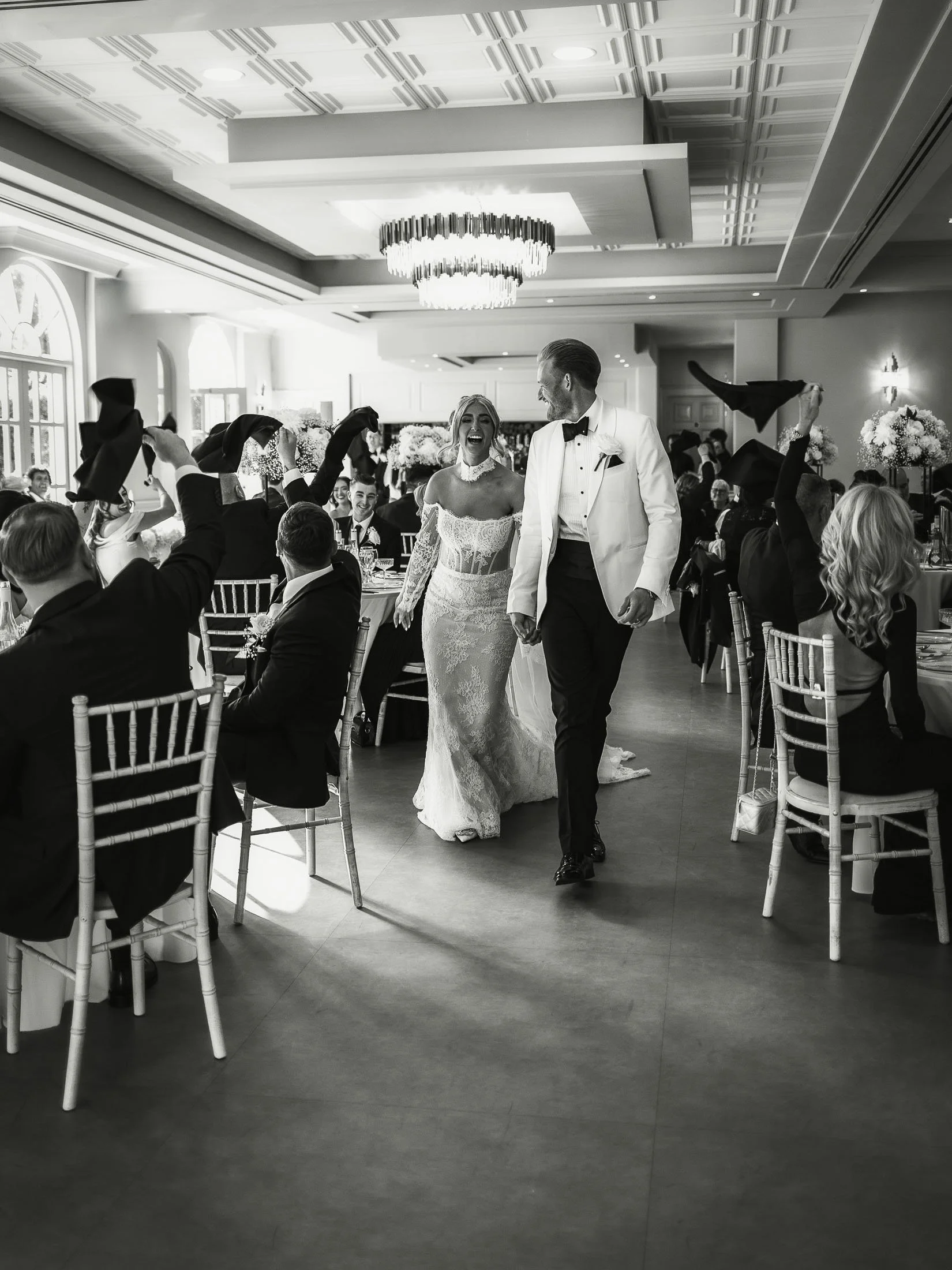 Bride and groom enter their wedding reception to a cheering crowd at The Orangery Maidstone.