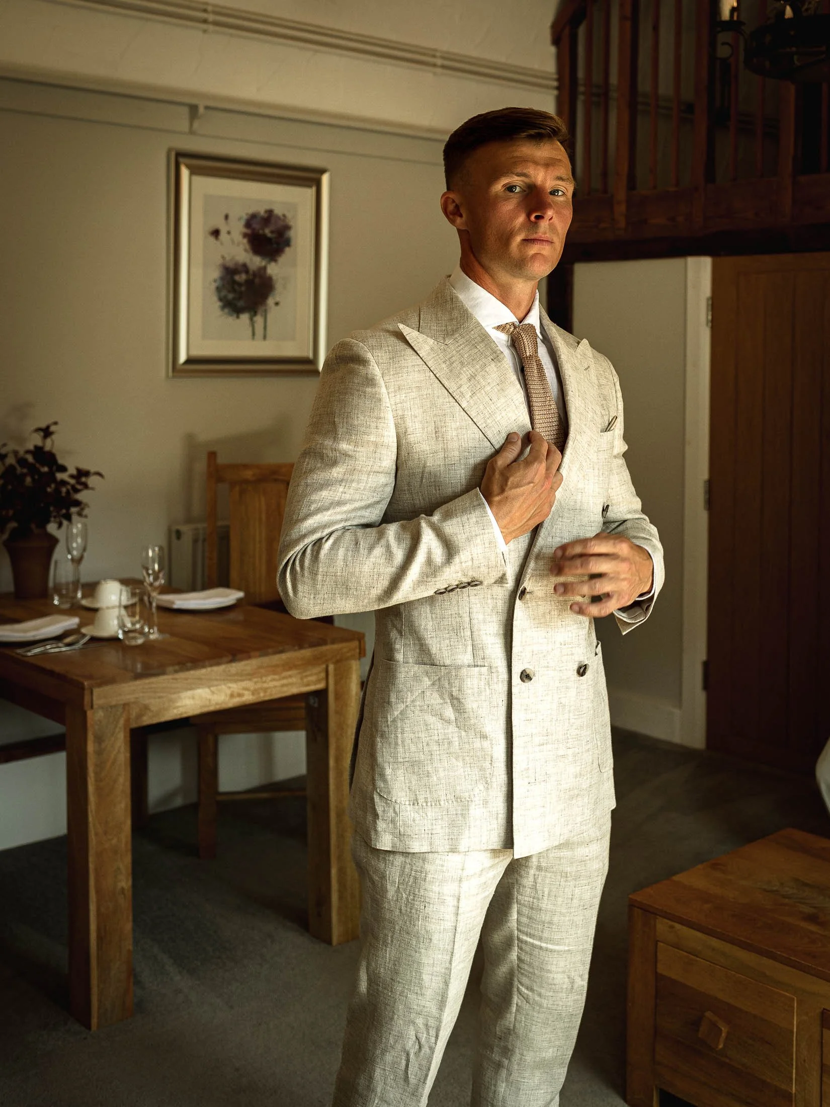 A groom portrait in the pump room at Winters Barns in Kent.